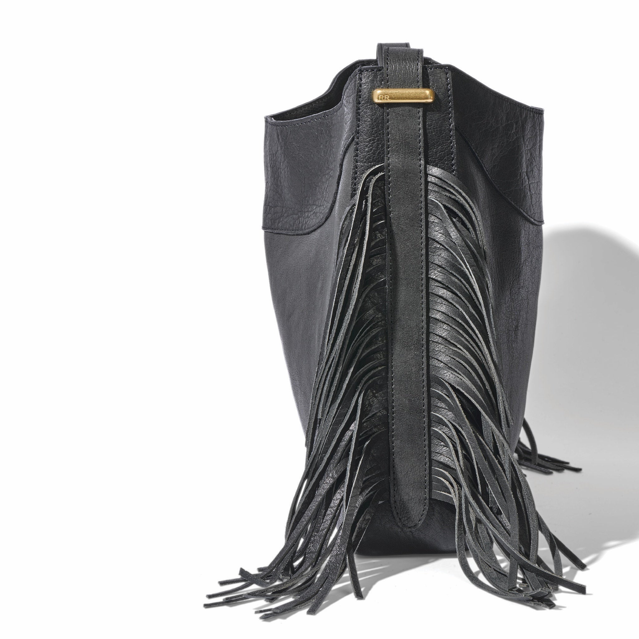 The fringe hobo in a white background. Leathers are sourced from regenerative ranches. SIDE VIEW
