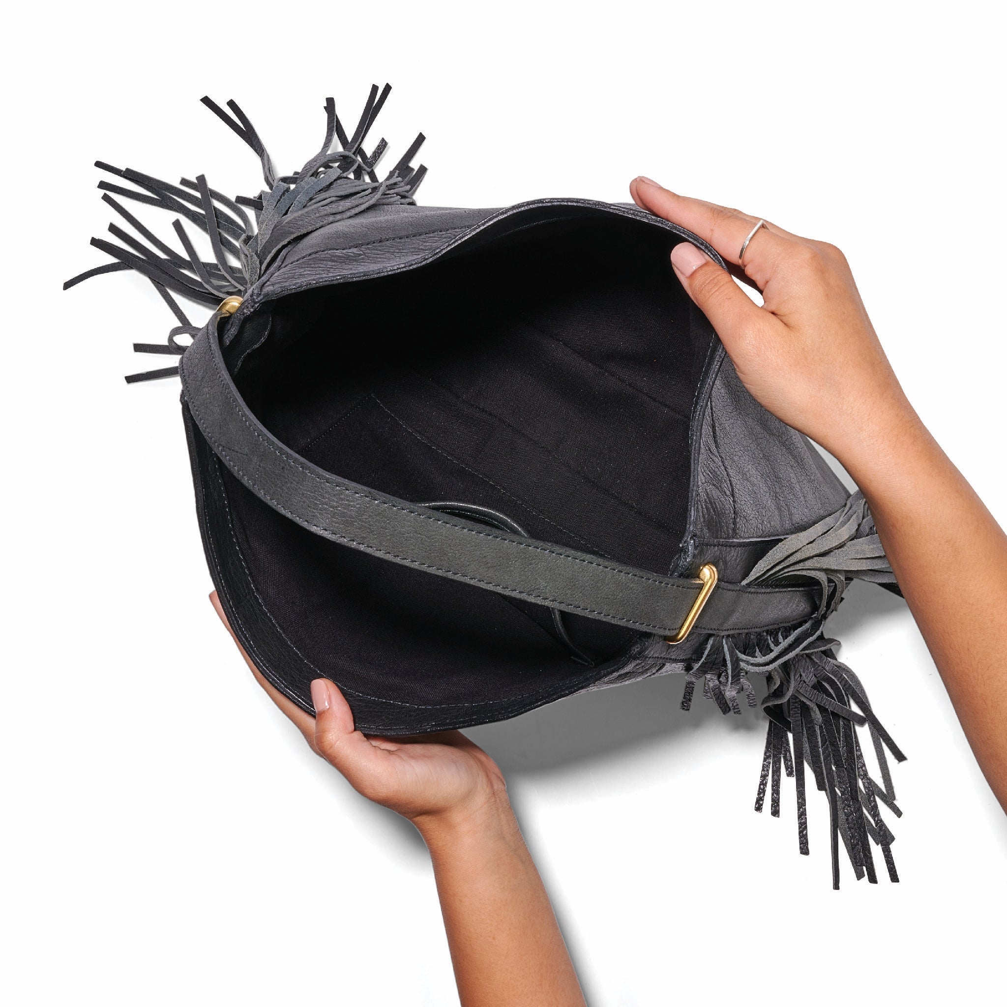 The fringe hobo in a white background. Leathers are sourced from regenerative ranches. INSIDE