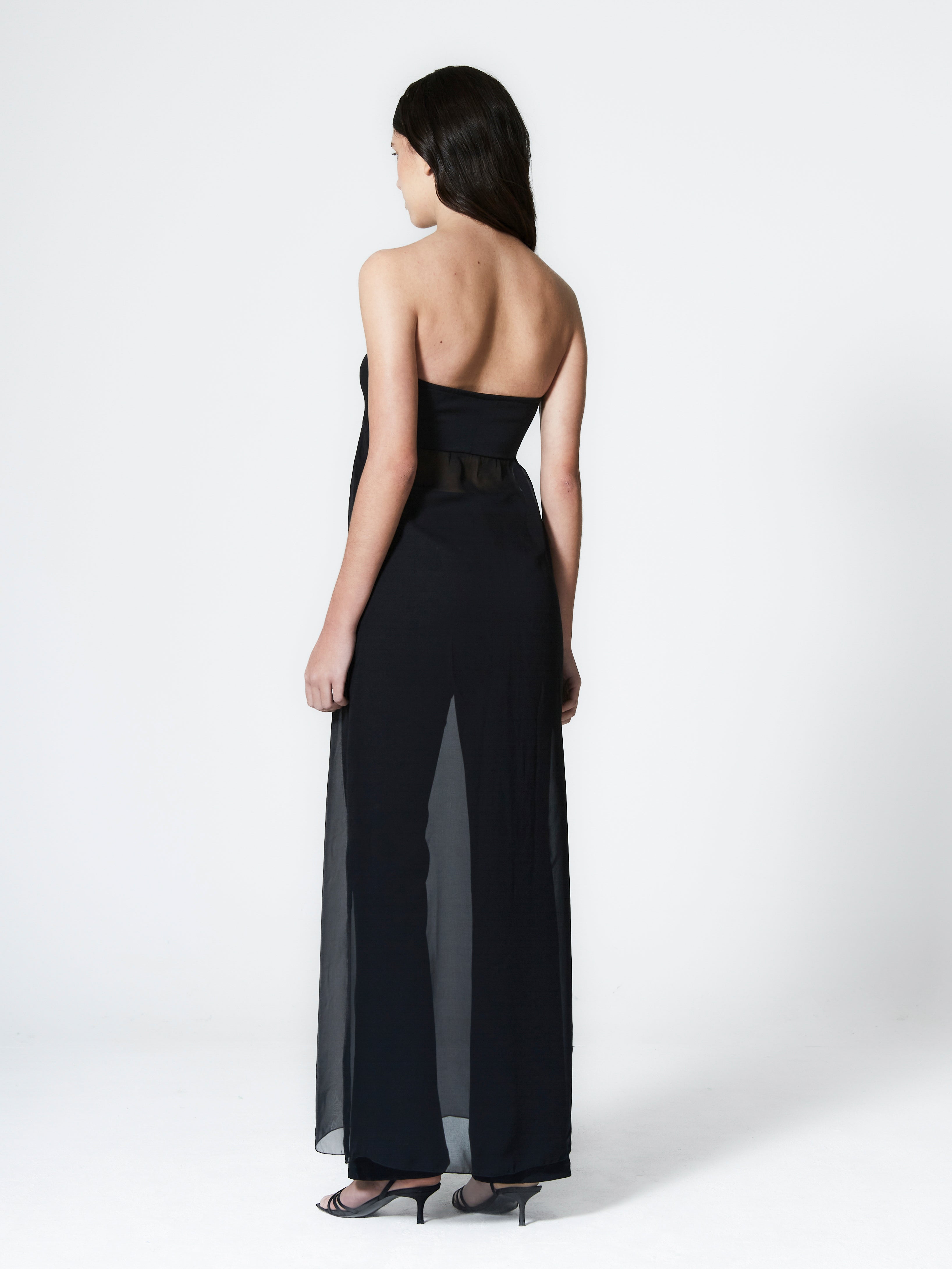 A model wearing the guilietta top in a white background. Made from fine and stretch deadstock wool paired with deadstock soft sheer viscose chiffon