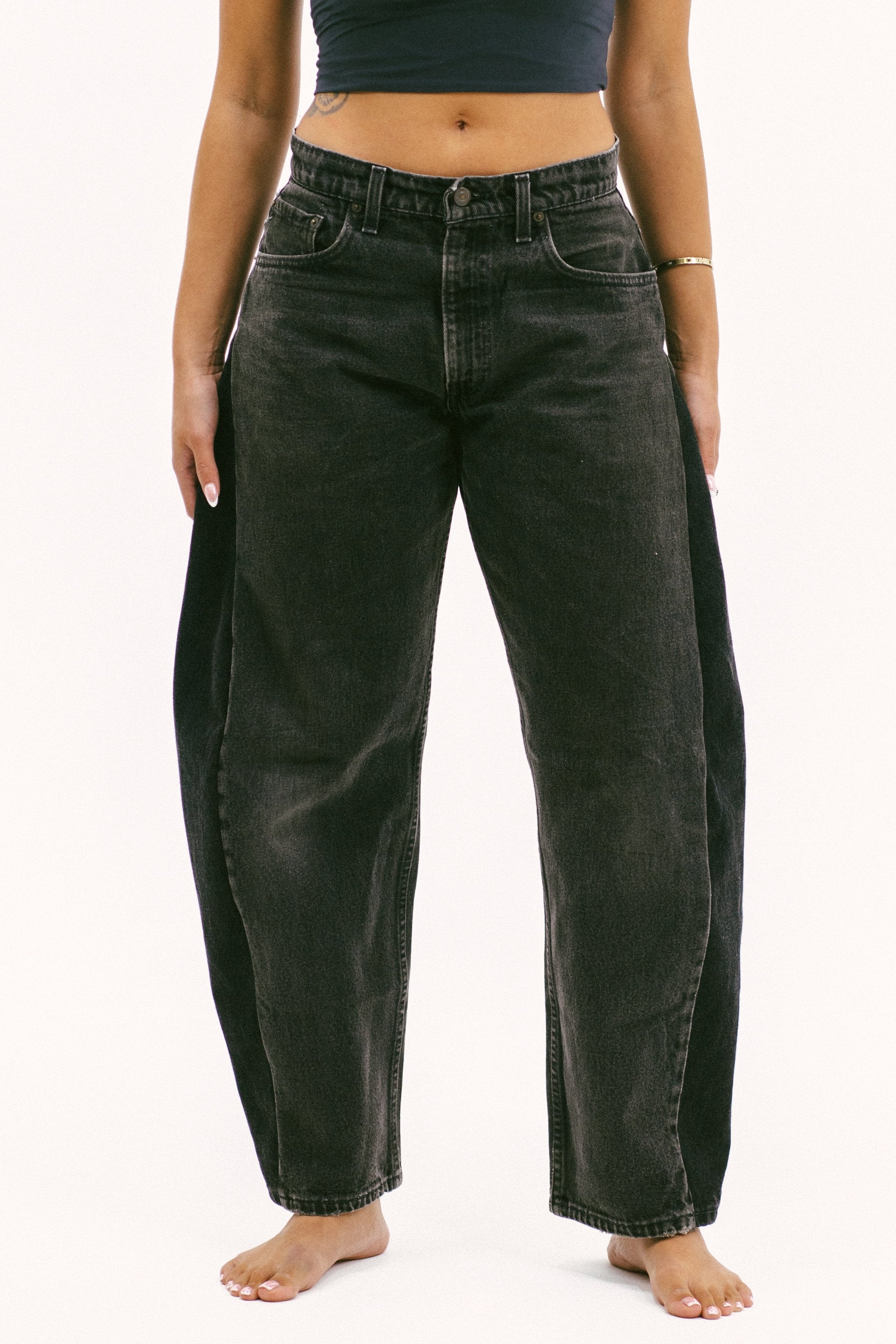 The horseshoe crop in a white background. 100% made from repurposed Levi’s. 