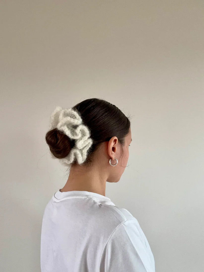 A model wearing the irine scrunchie in a white background. Handmade in London!