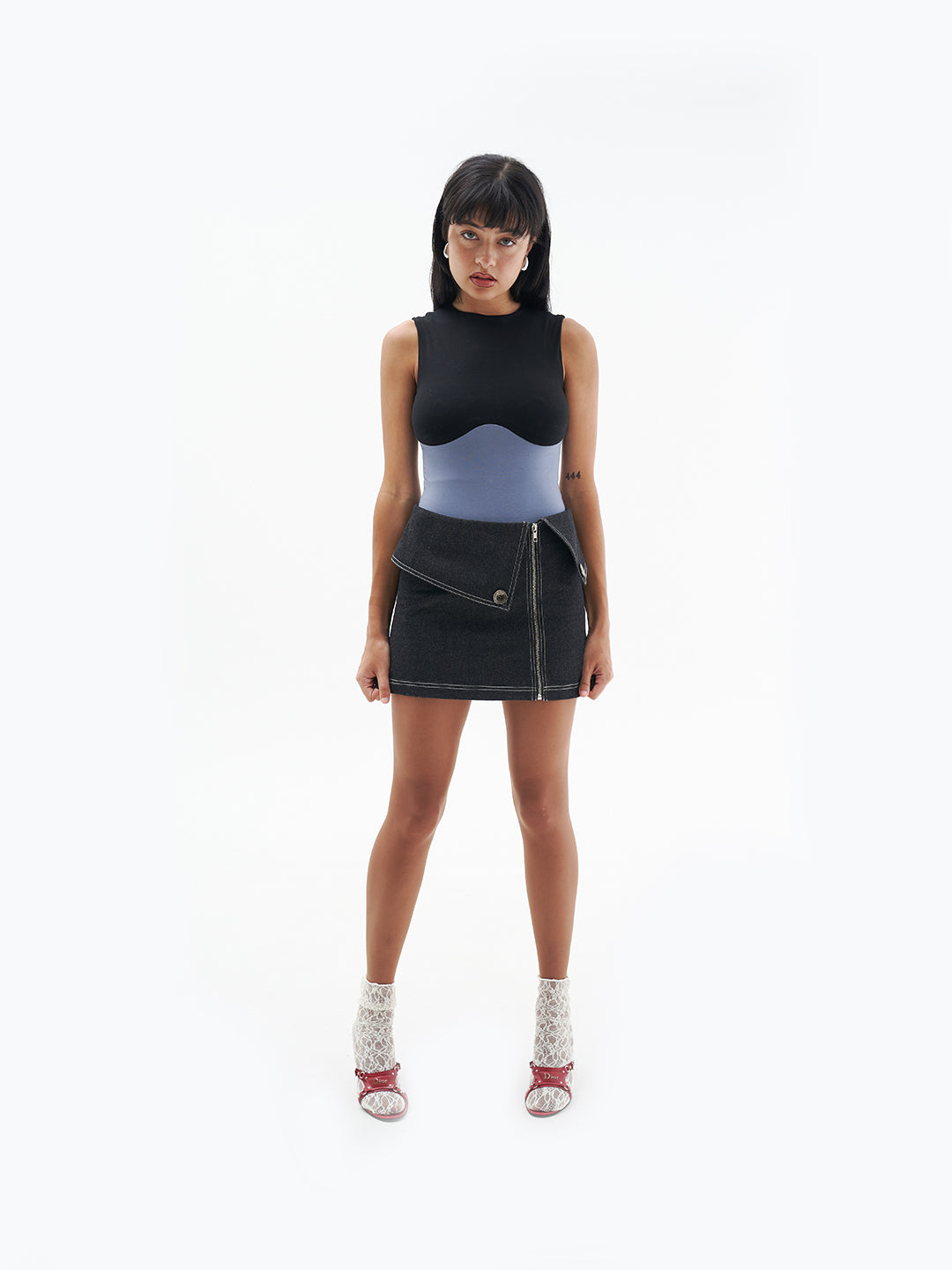 A model wearing the Jackie Skirt in a white background. 100% made from sustainable materials.