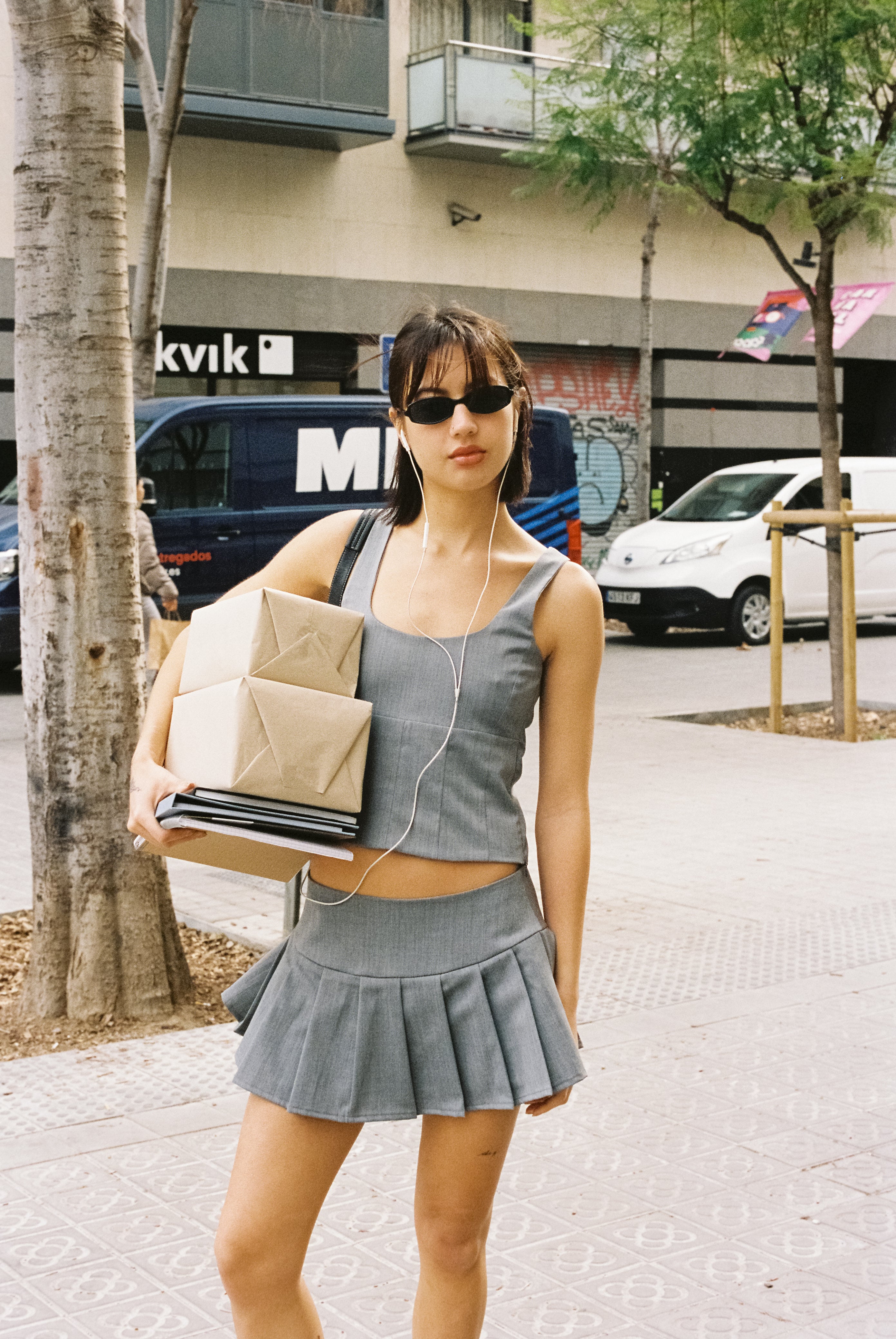 A model wearing the Kaia skirt in an aesthetically background. 100% made from sustainable deadstock material.