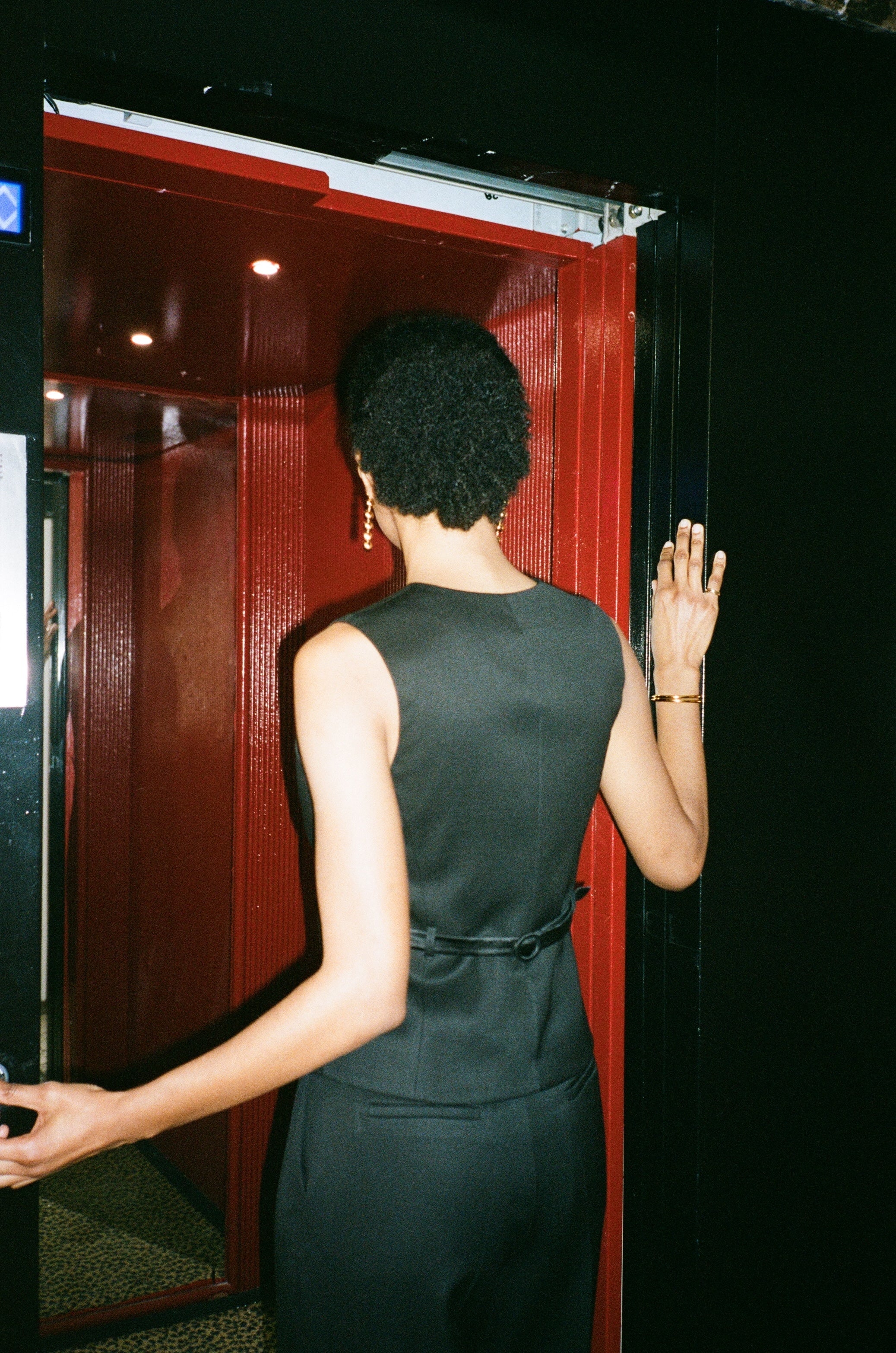 A model wearing the kate wool and black satin vest in an aesthetically background. 100% upcycled wool and satin. 