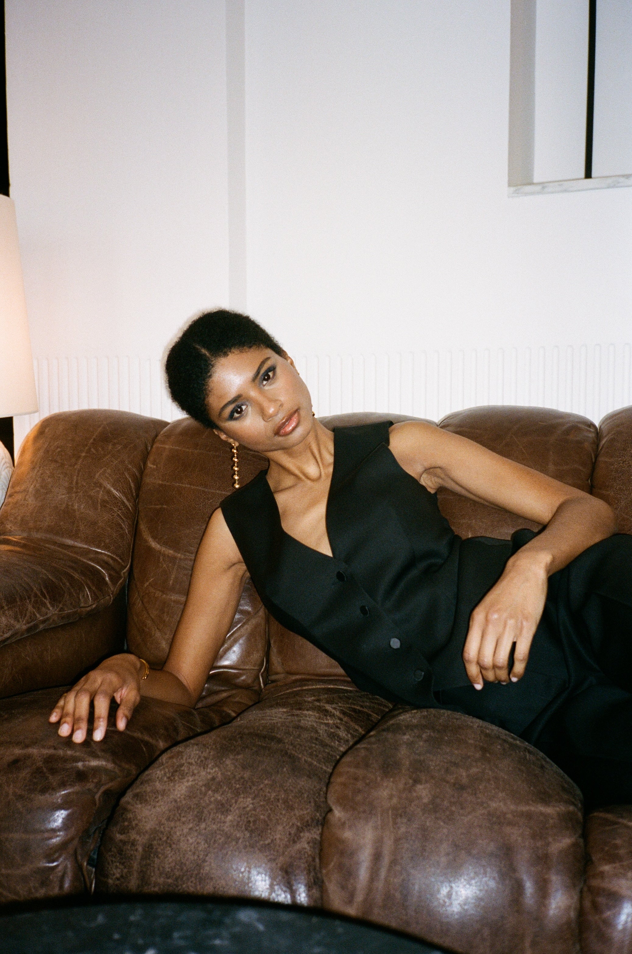 A model wearing the kate wool and black satin vest in an aesthetically background. 100% upcycled wool and satin.