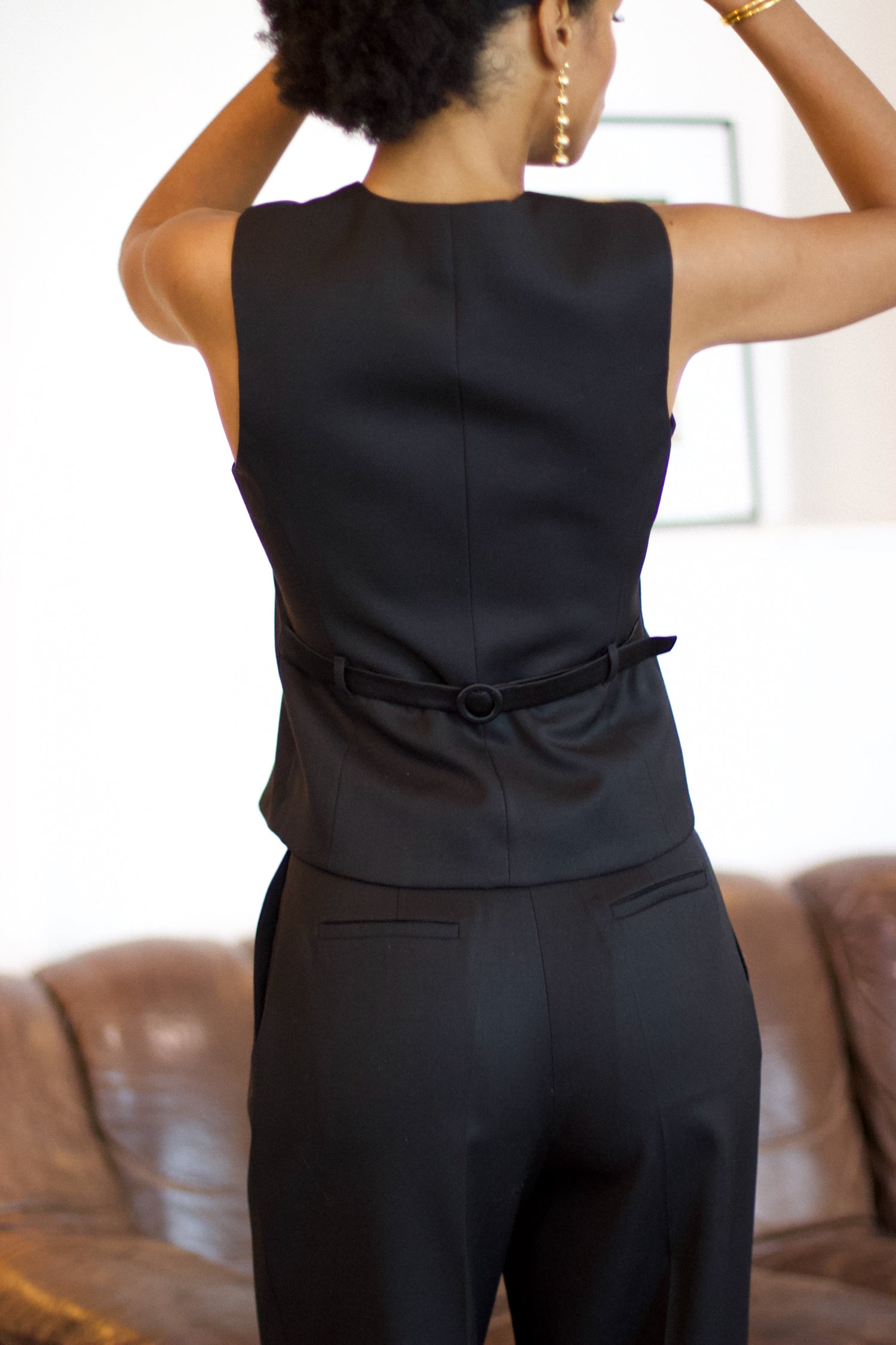 A model wearing the kate wool and black satin vest in an aesthetically background. 100% upcycled wool and satin.