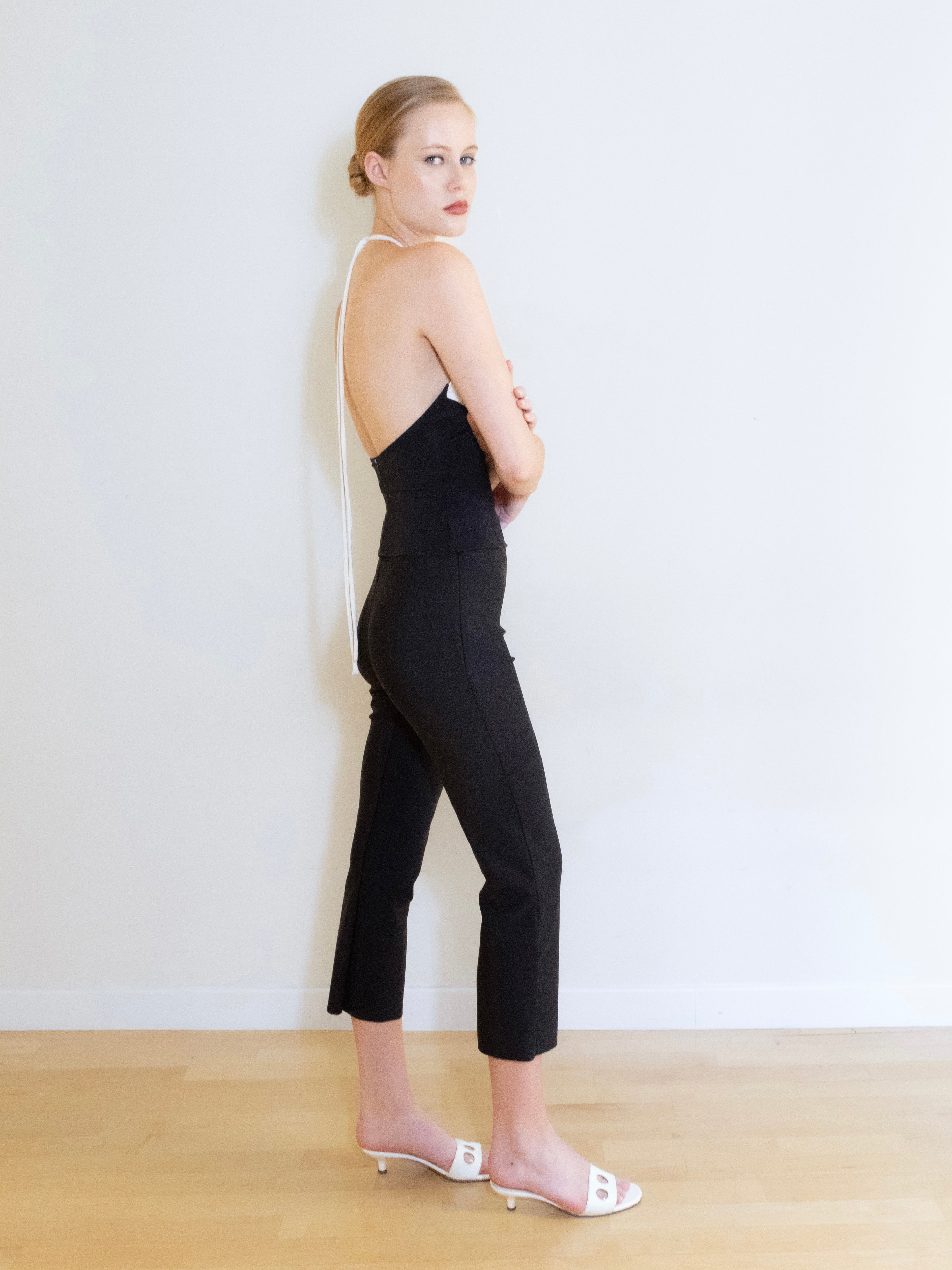 A model wearing the knit capri pants in a white background. Made from soft, stretchy deadstock fabric