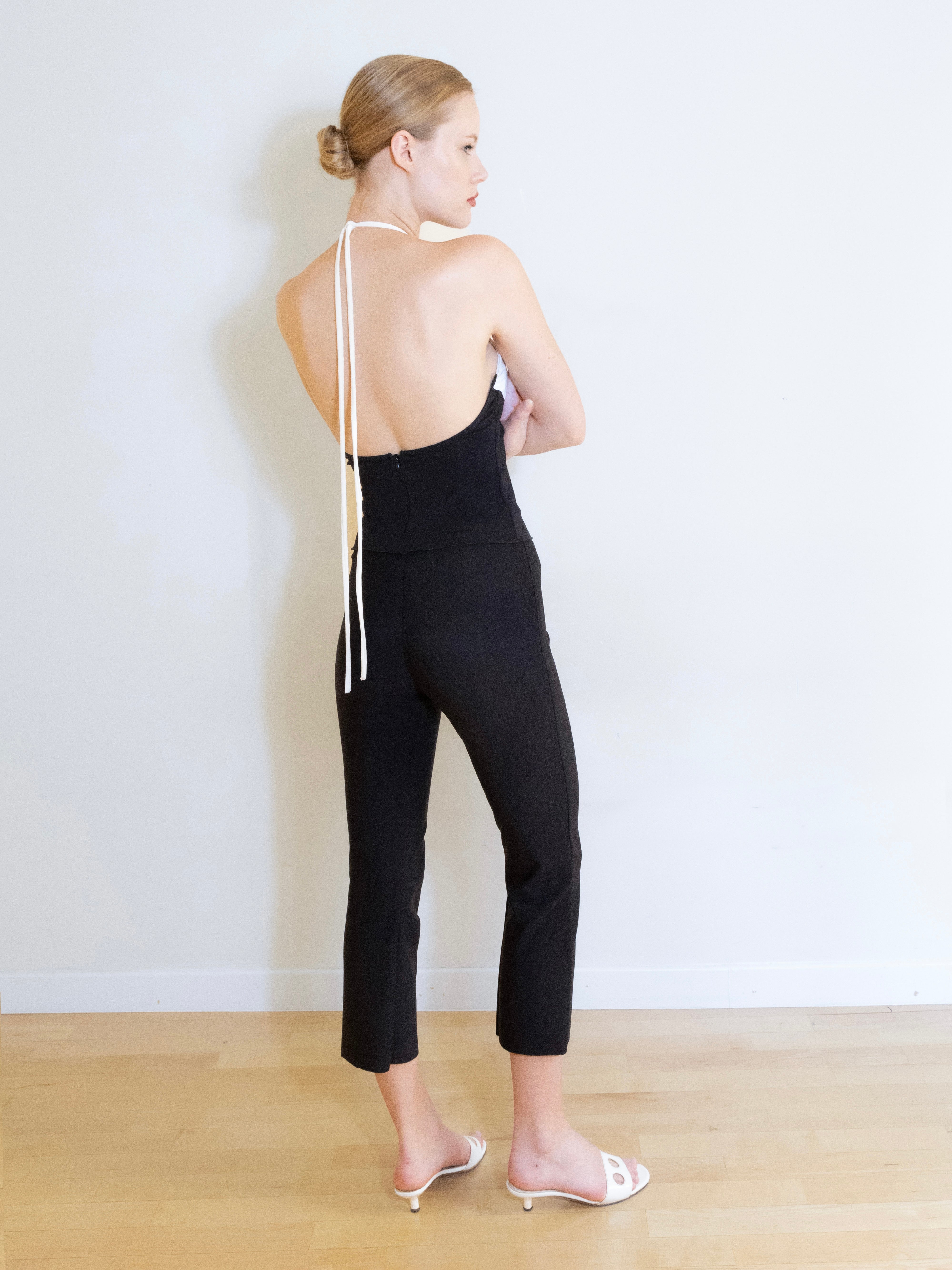 A model wearing the knit capri pants in a white background. Made from soft, stretchy deadstock fabric