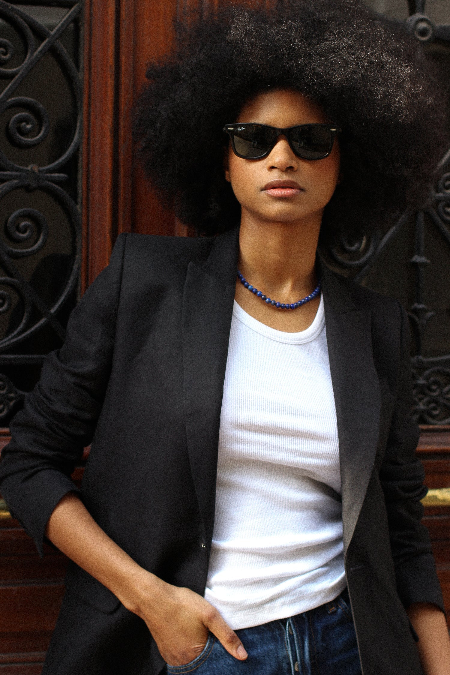 A model wearing the lauren black linen twill blazer in an aesthetically background. 100% upcycled GOTS certified linen.