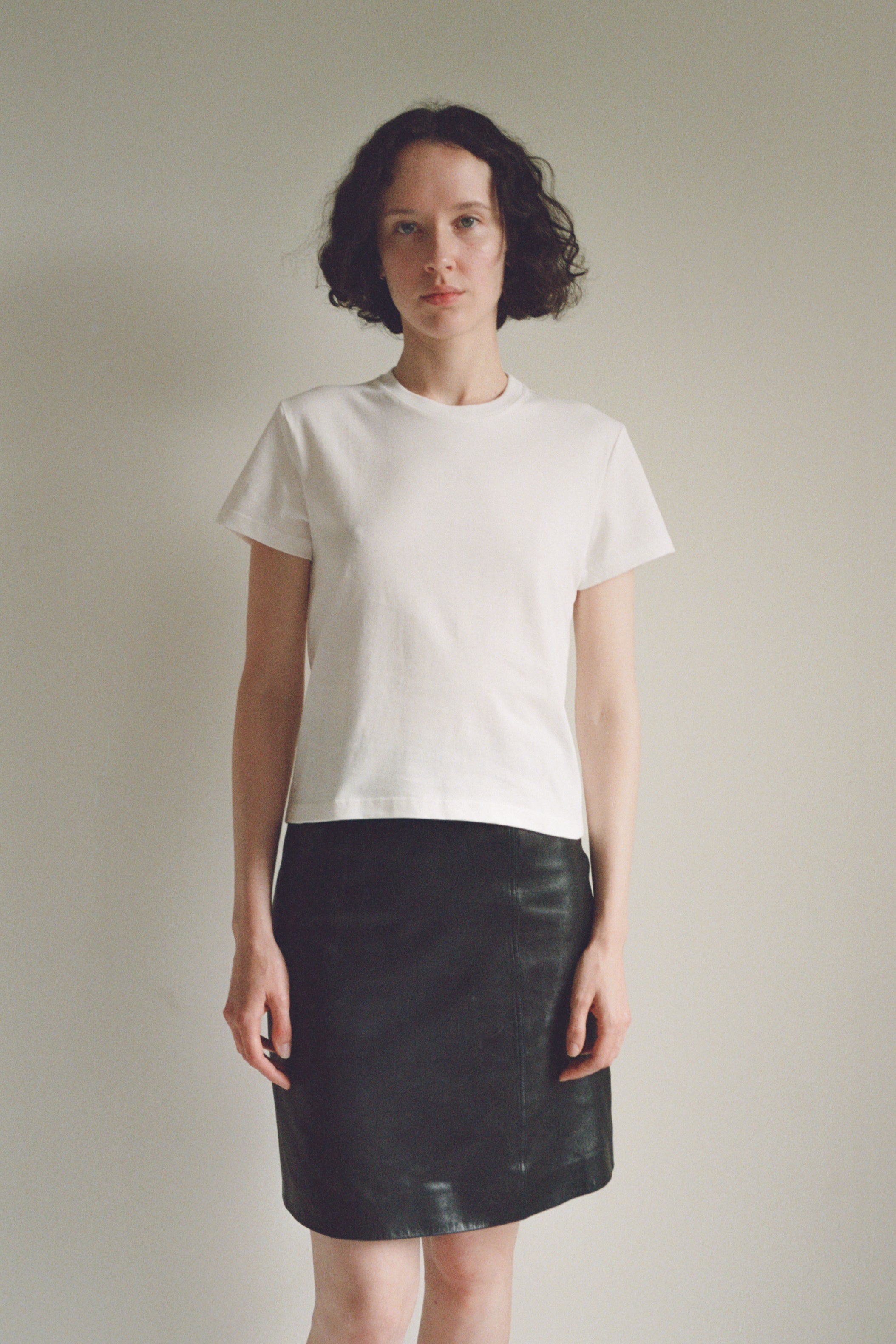 A model wearing the little tshirt in a white background. 100% made from organic grown cotton.