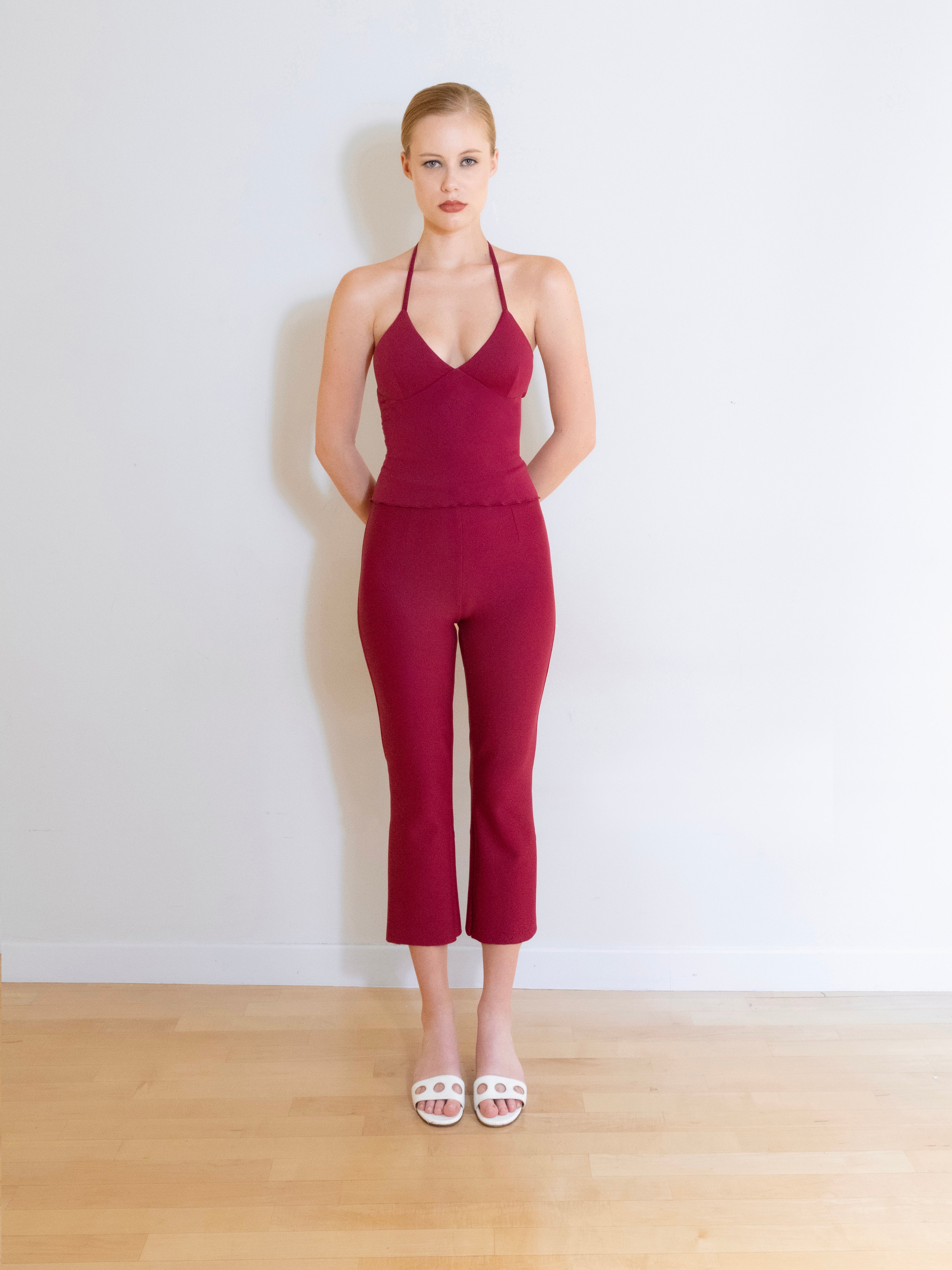 A model wearing the Luna knit capri pants in a white background. Made from soft, stretchy deadstock fabric