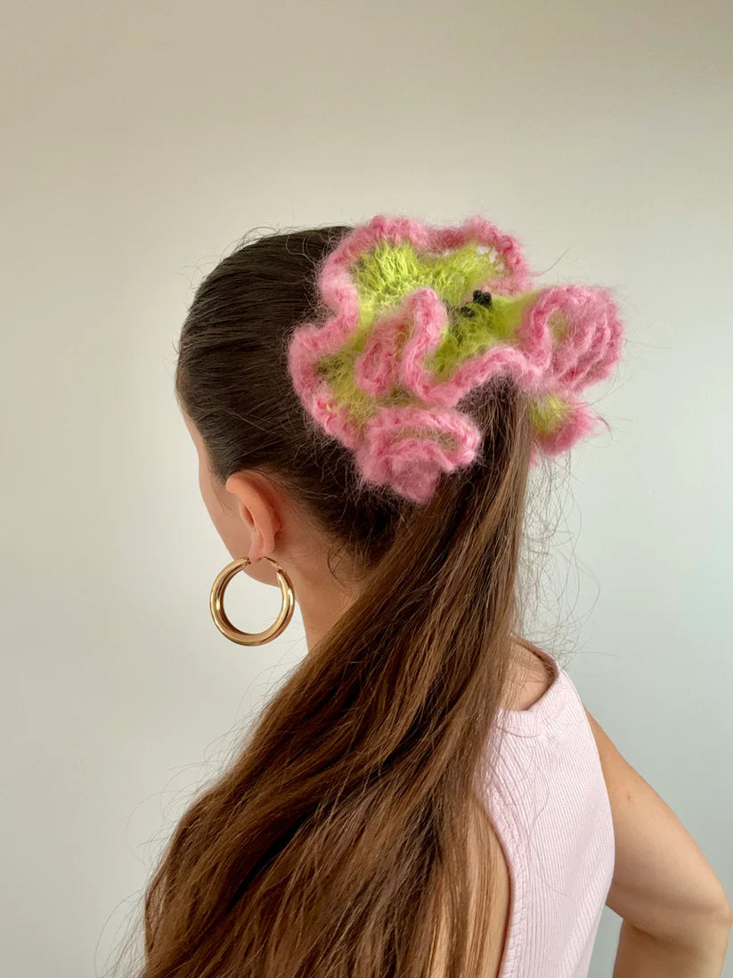 A model wearing the maeve scrunchie in a white background. Handmade in London!