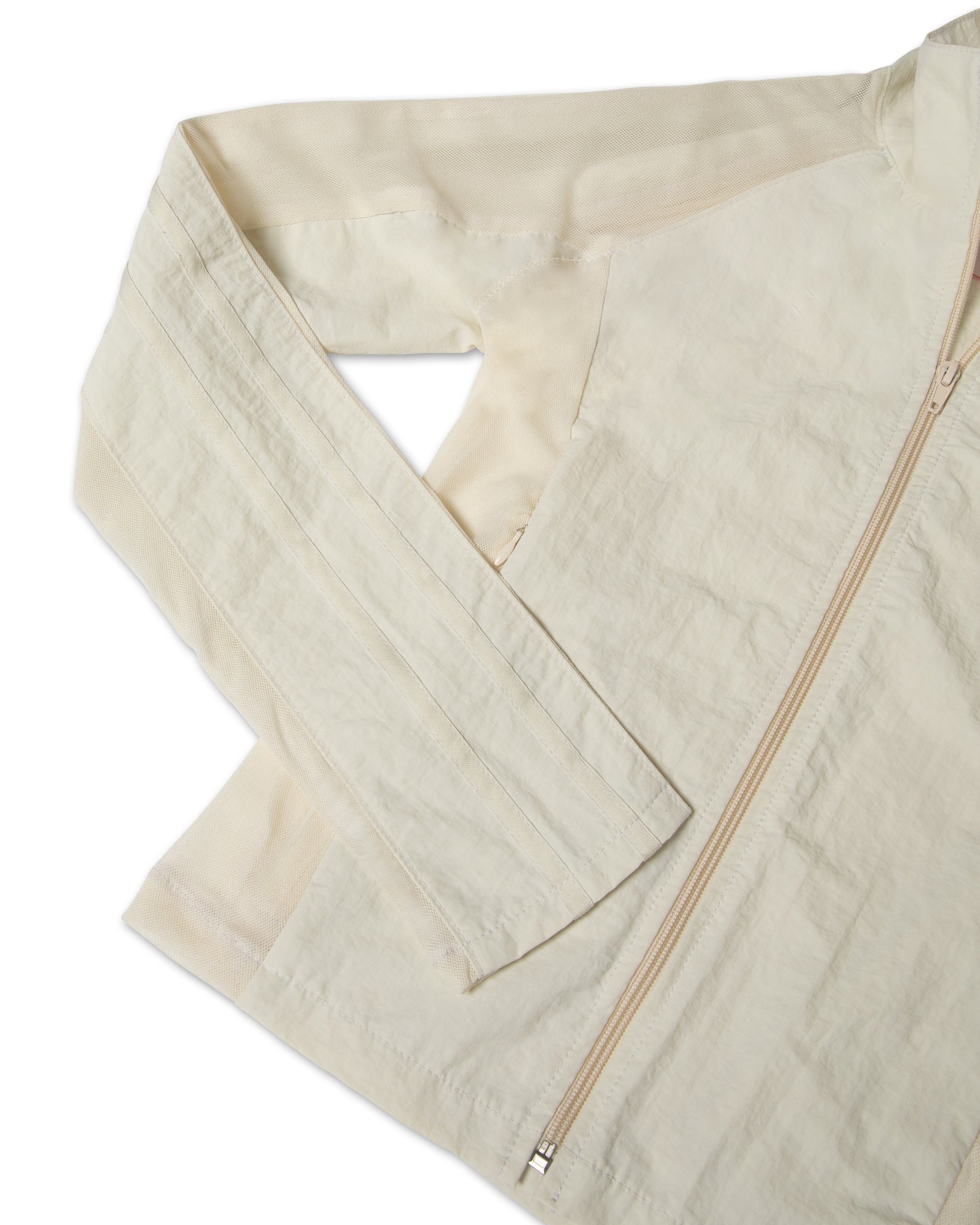 Close-up of the mesh cream jacket in a white background. 100% made from deadstock nylon.