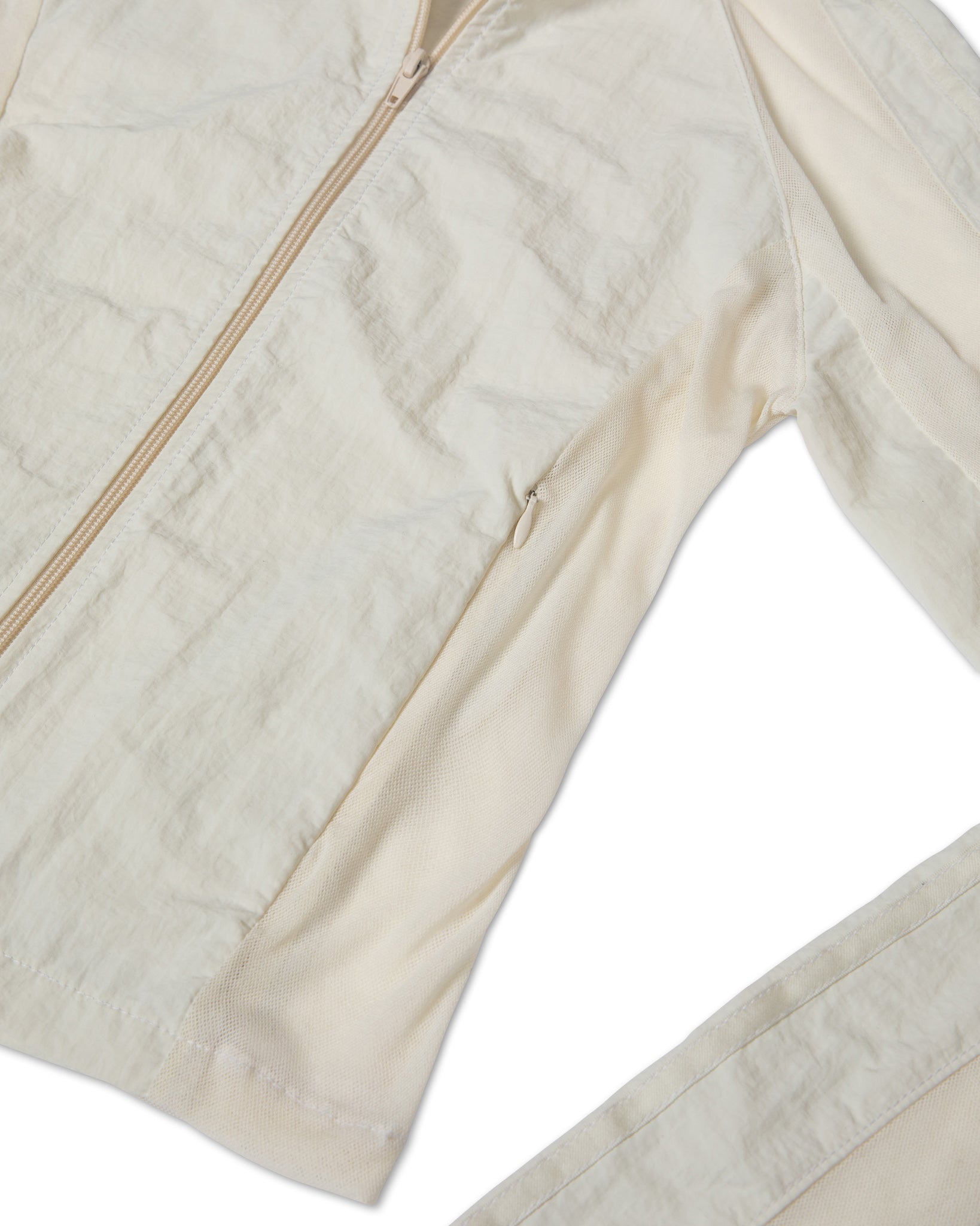 Close-up of the mesh cream jacket in a white background. 100% made from deadstock nylon.