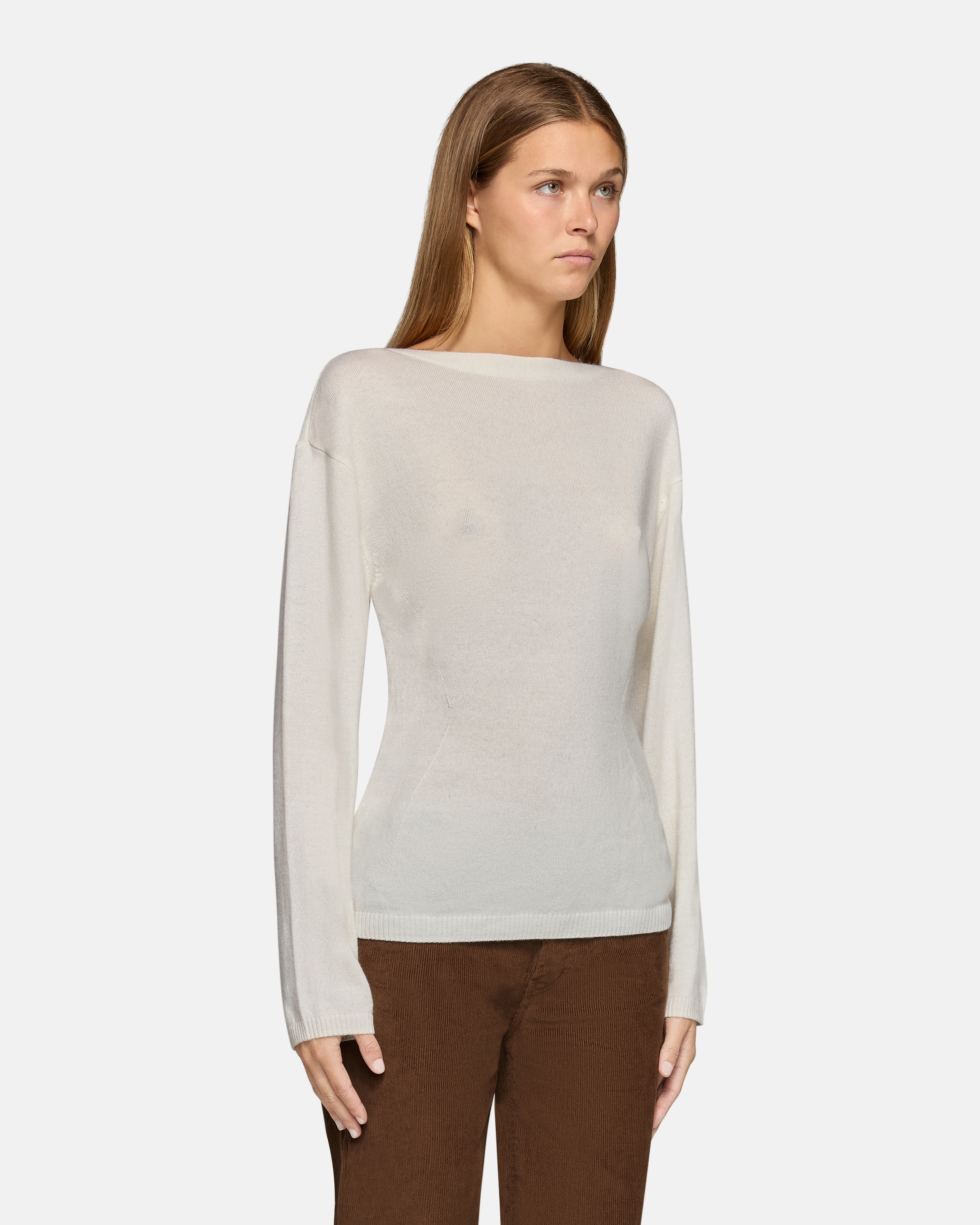 A model wearing the millie boat neck sweater in white in a white background. 100% made from cotton.