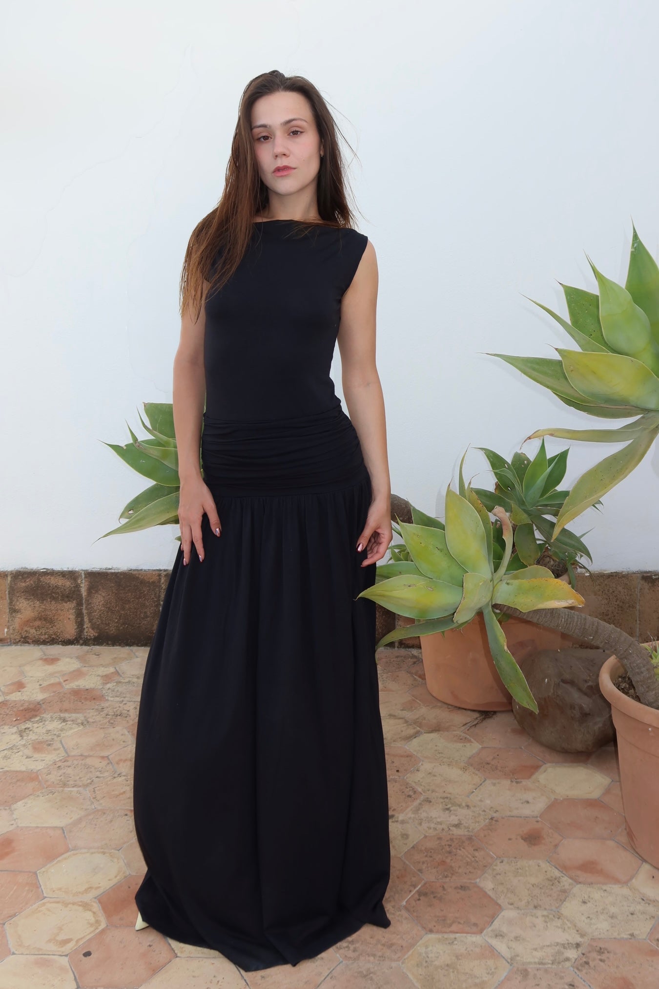 A model wearing the phase silk jersey dress in an aesthetically background. 100% made from deadstock.