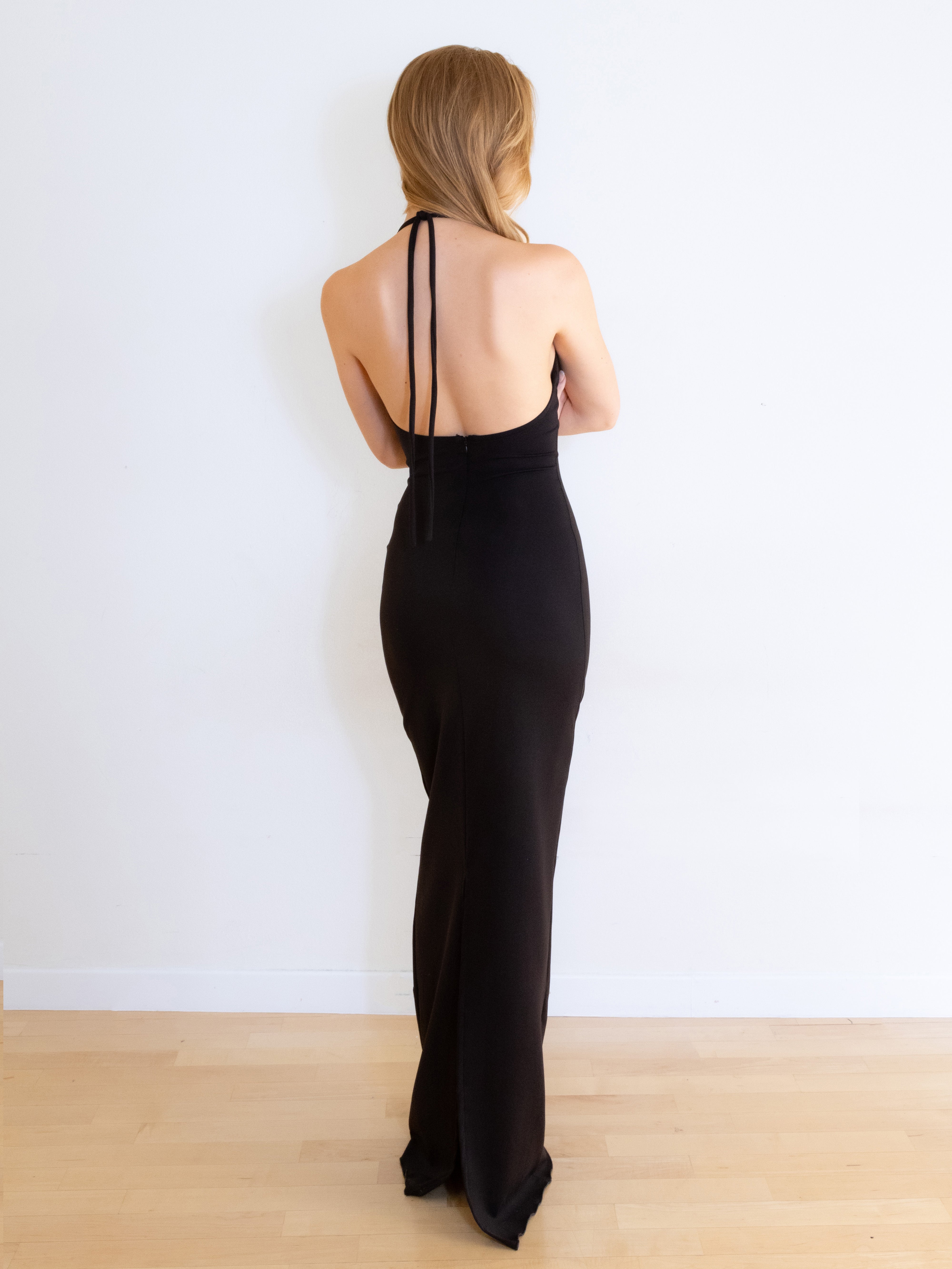 A model wearing the pia knit maxi dress in a white background. Made from soft, stretchy deadstock knit fabric