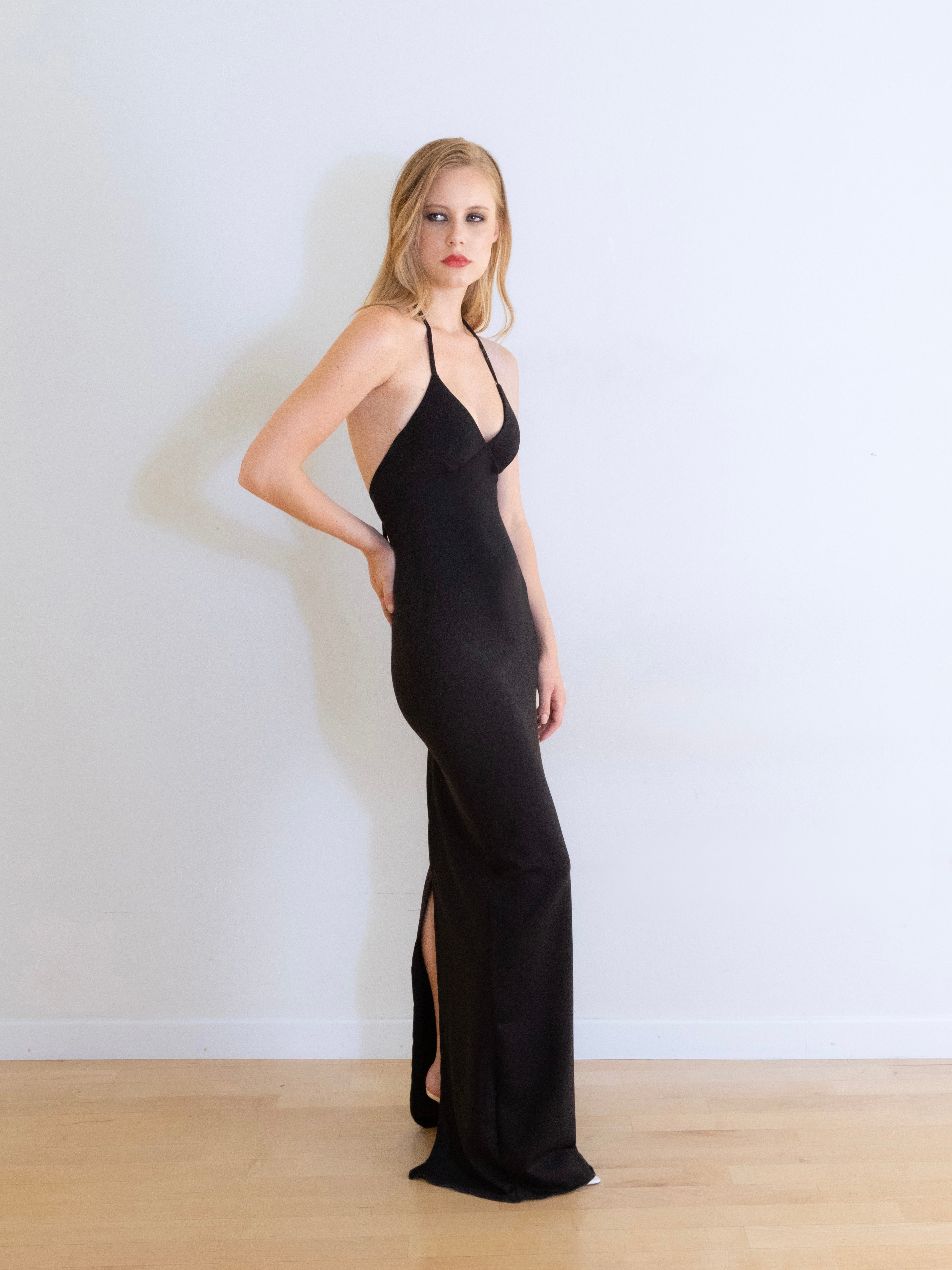 A model wearing the pia knit maxi dress in a white background. Made from soft, stretchy deadstock knit fabric