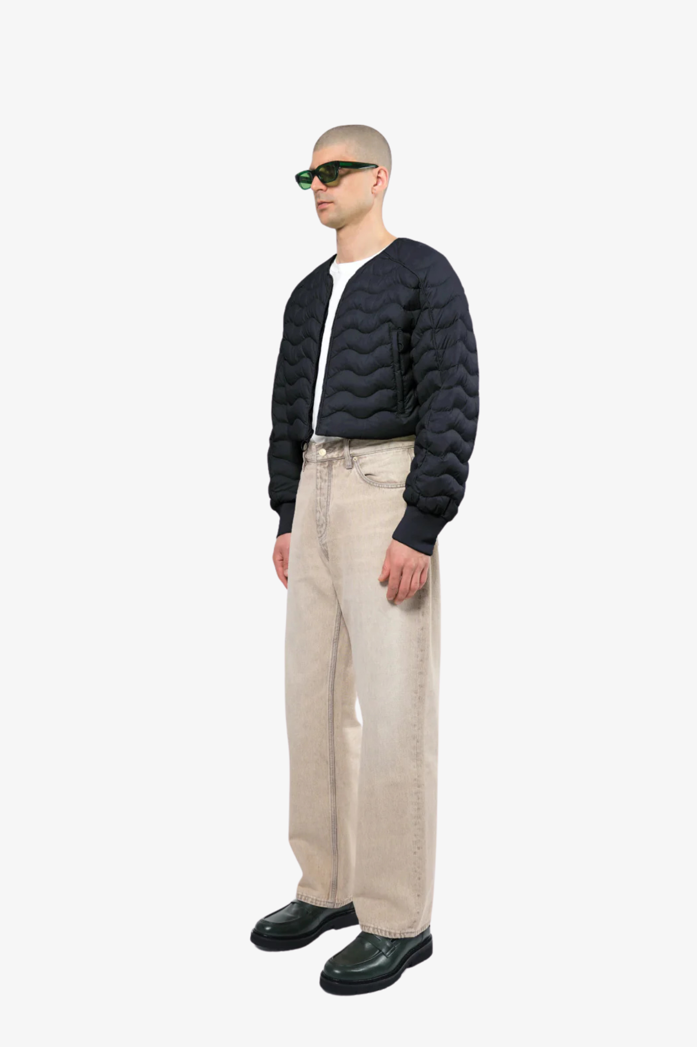 Model wearing a light crop puffer jacket in a white background. 100% made from recycled fabric. 