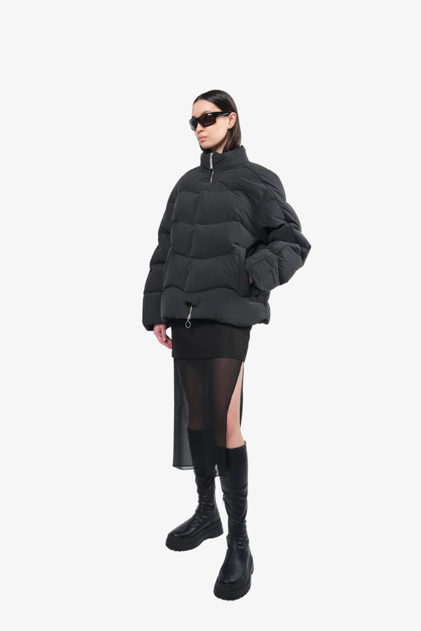 Model wearing a puffer jacket in a white background. 100% made from recycled fabric. 