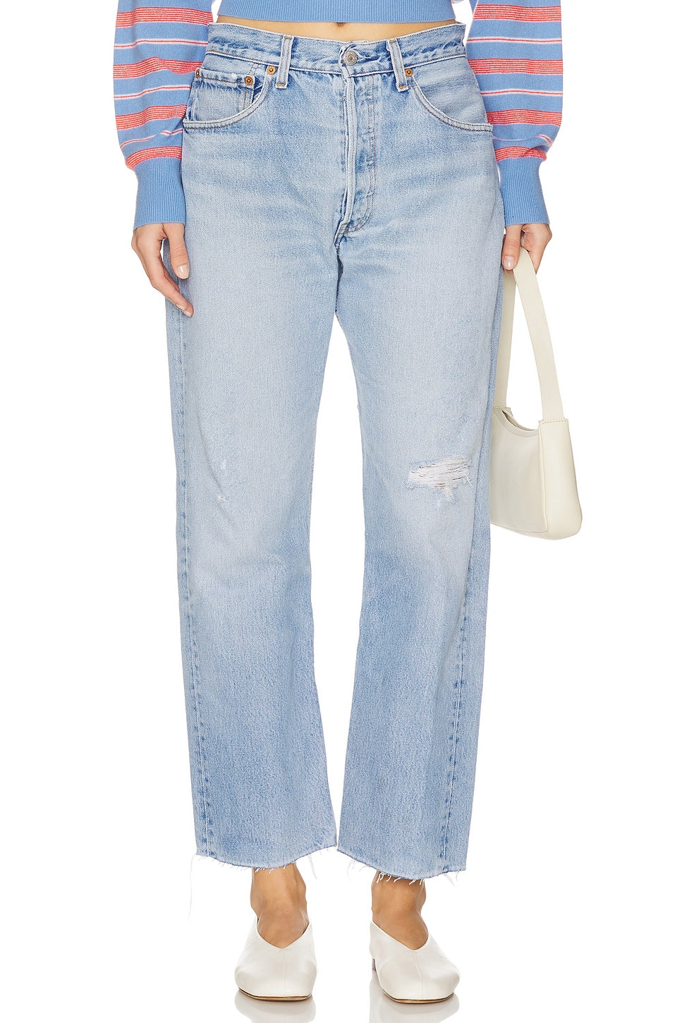 Model wearing the relax raw hem in a white background. 100% made from repurposed Levi’s. 