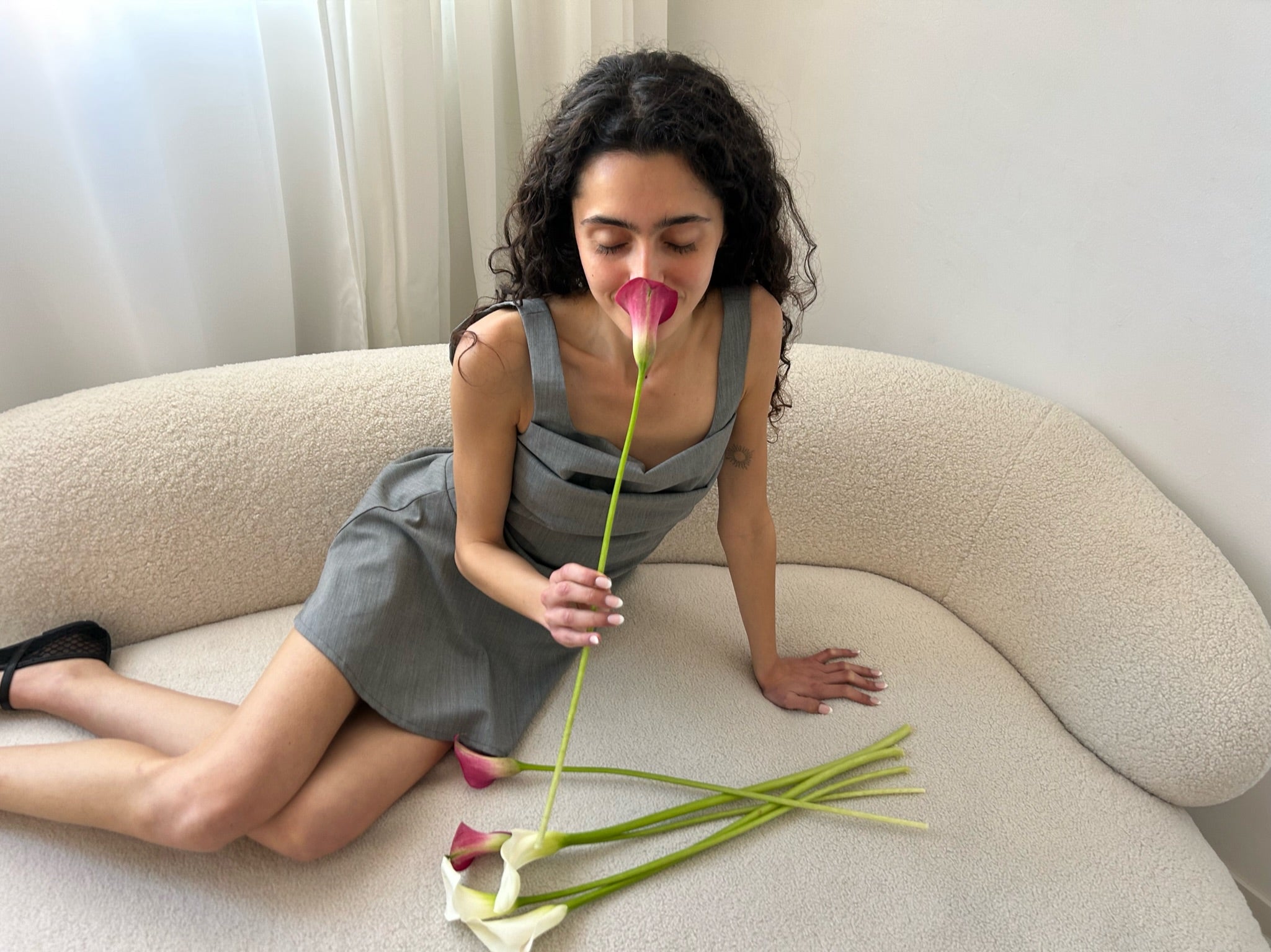 A model wearing the rose dress in an aesthetically background. 100% made from sustainable deadstock material.