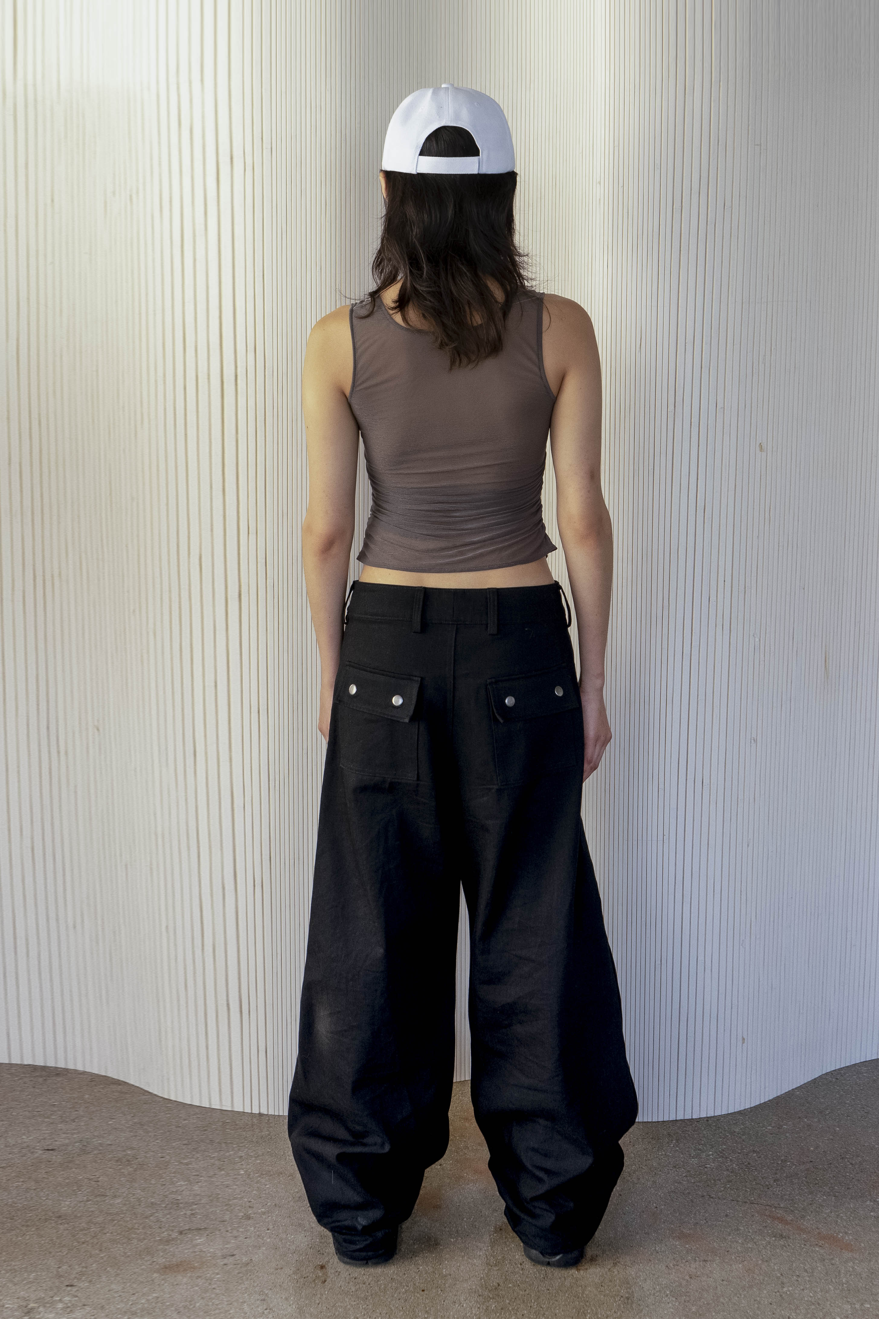 A model wearing the ruched sheer tank in an aesthetically background. 100% deadstock, Japanese sheer polyester