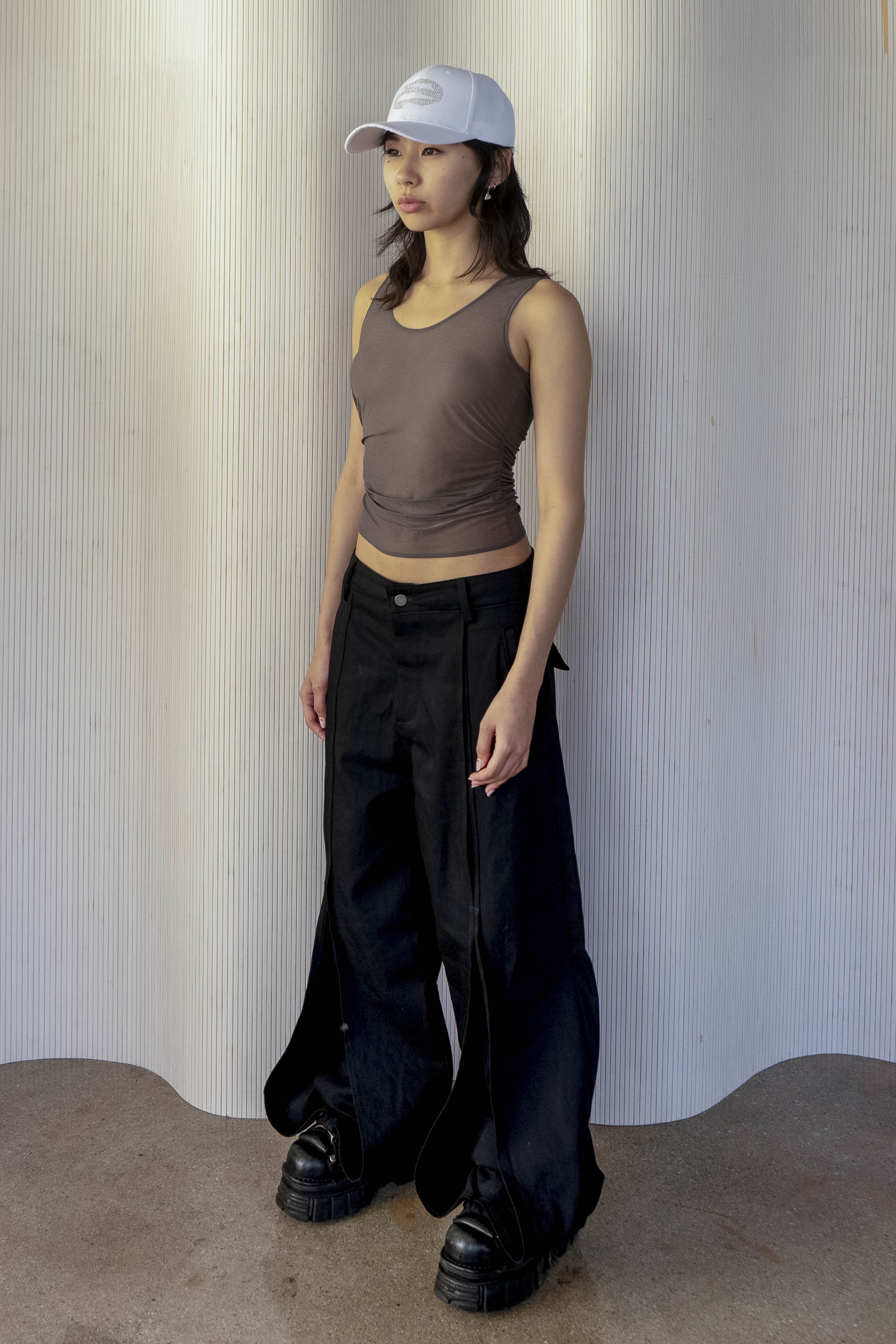 A model wearing the ruched sheer tank in an aesthetically background. 100% deadstock, Japanese sheer polyester