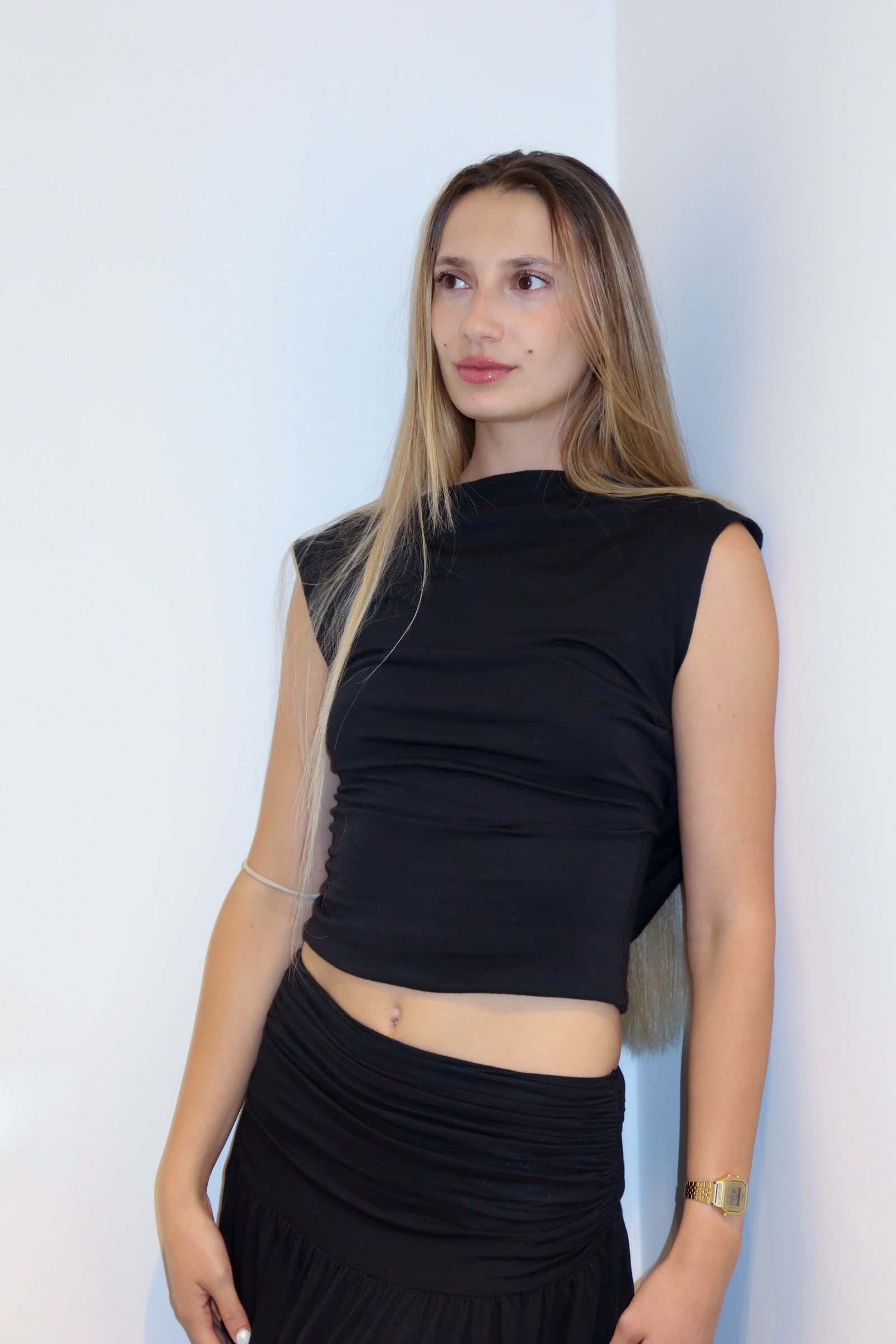 Model wearing the silk jersey top in a white background. 100% made from deadstock.