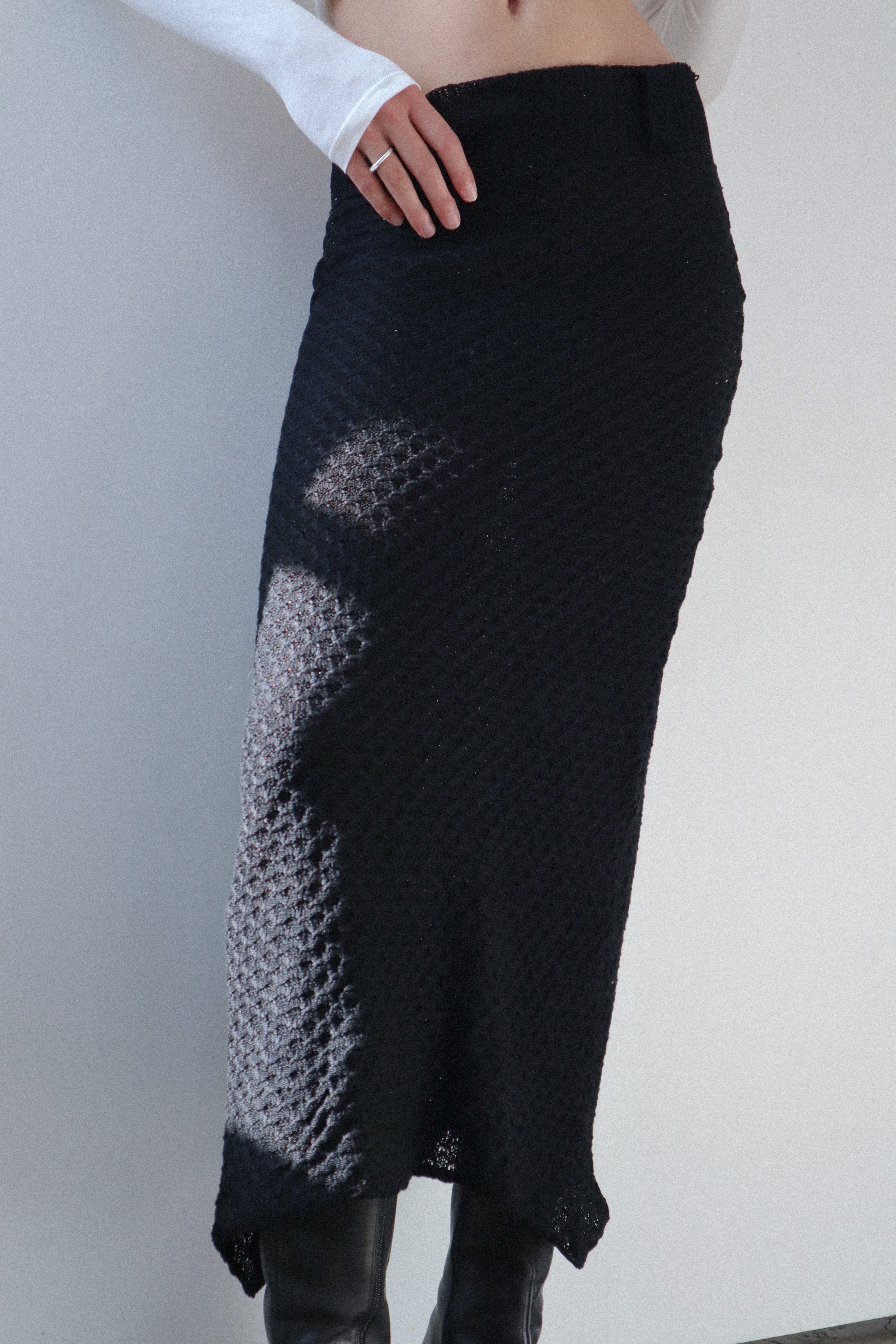 A model wearing the slye skirt in a white background. 100% black cotton knit.