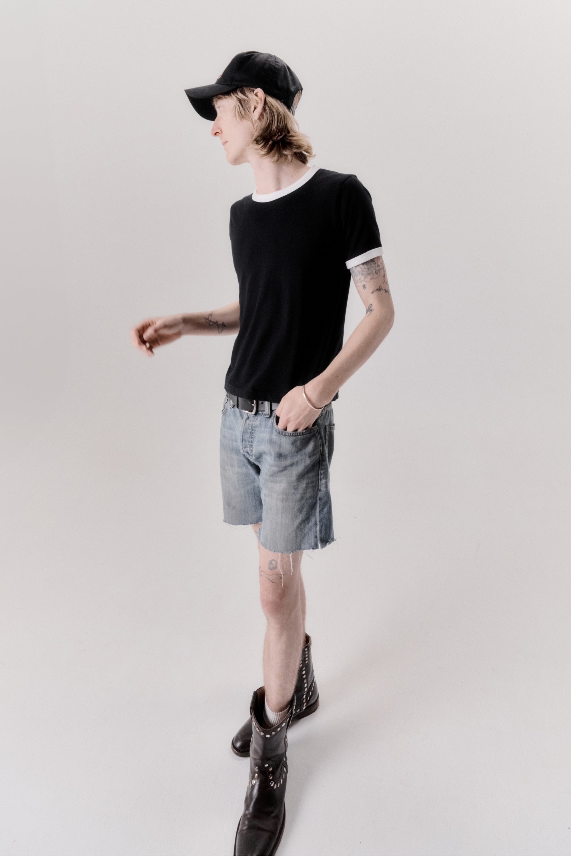 A model wearing the star ringer tshirt in black with white contrast in a white background. 100% made from organic grown cotton. 