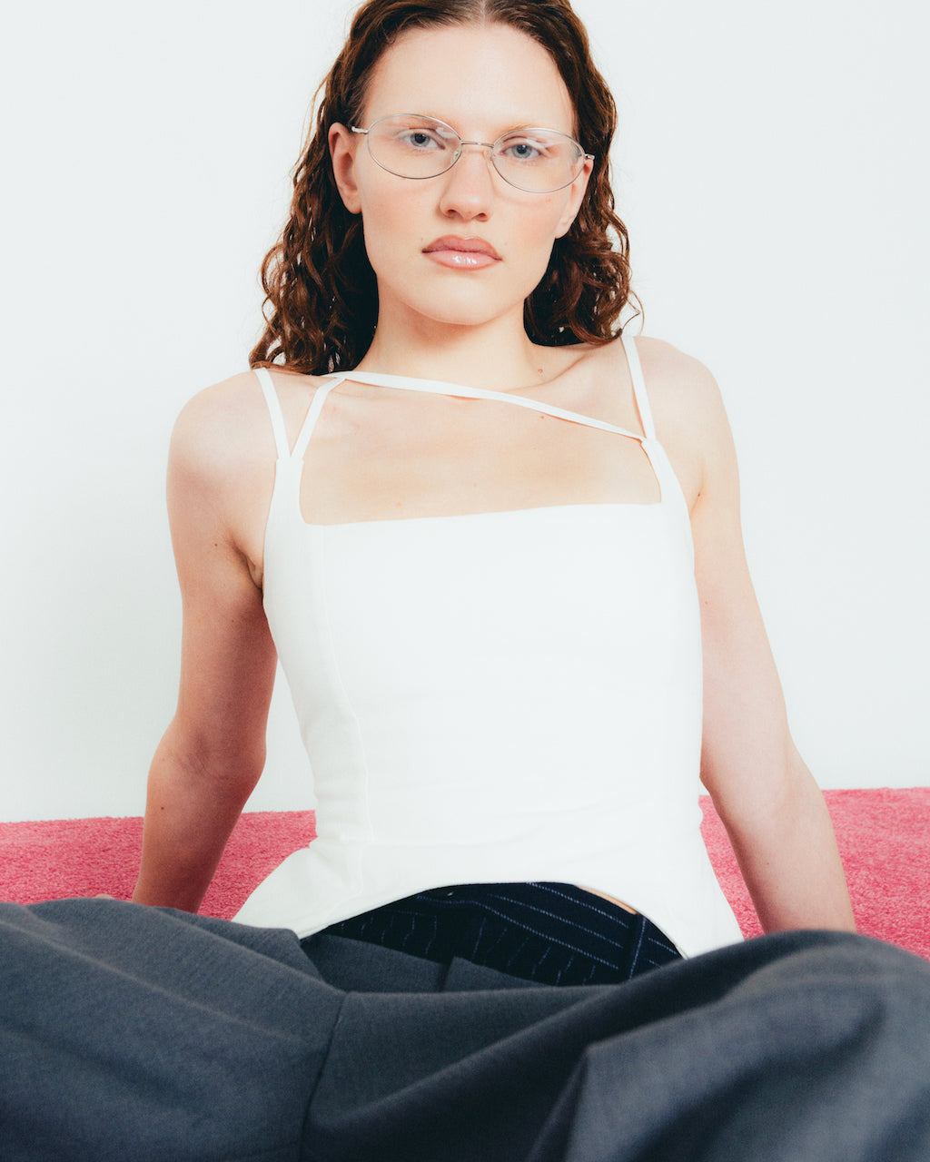 A model wearing the white u top in a white background. Heavyweight 100% Organic Cotton.