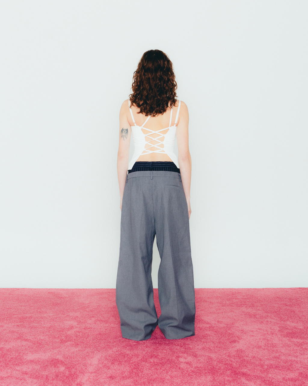 A model wearing the white u top in a white background. Heavyweight 100% Organic Cotton.