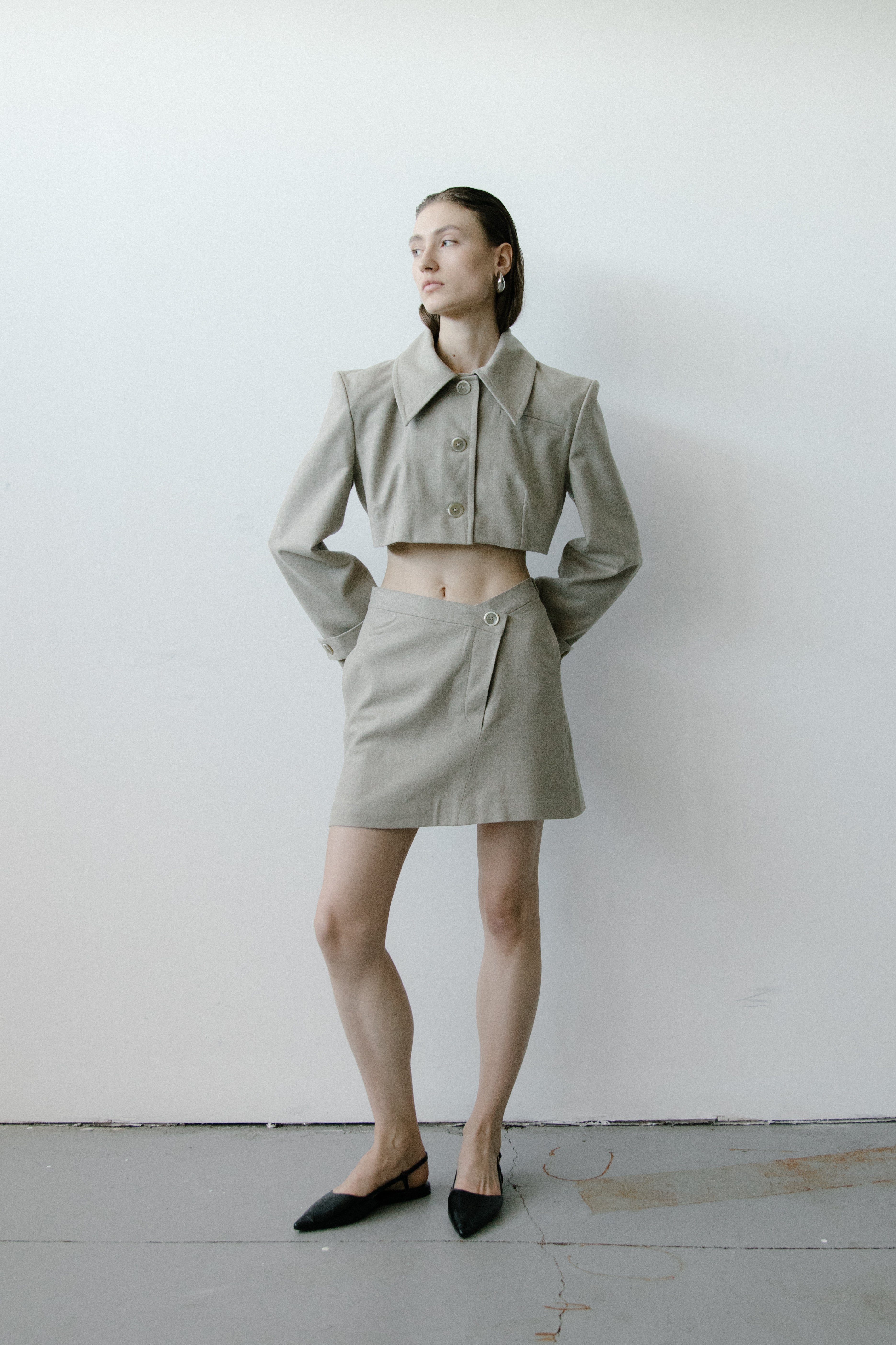 A model wearing the triangle taupe skirt in a white background. 100% made from organic cotton.