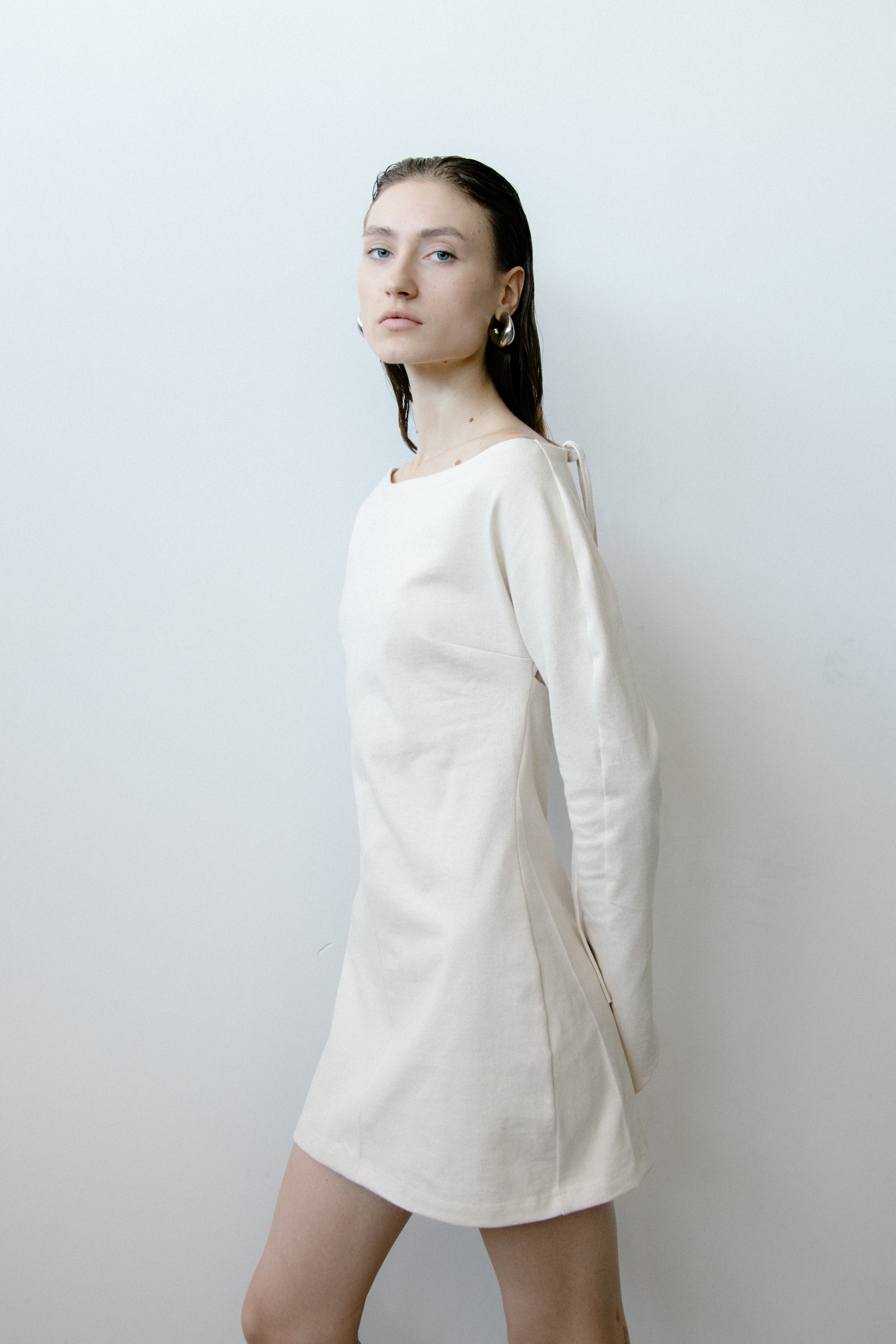 A model wearing the triangle mini dress in a white background. 100% made from organic cotton. 