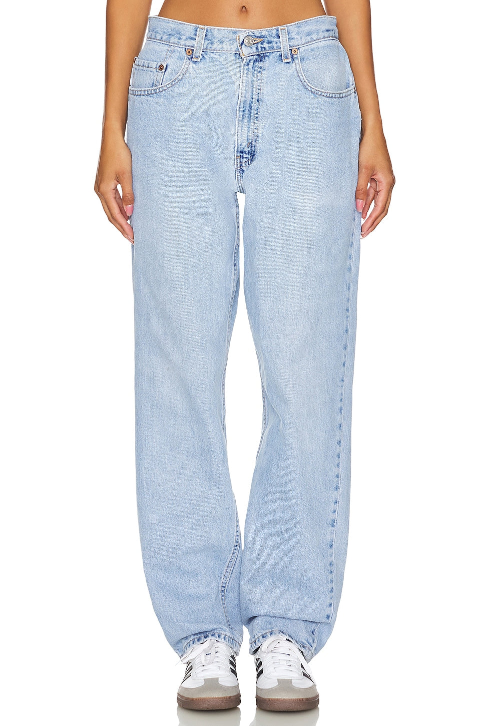 Model wearing an ultra baggy customs in a white background. 100% made from repurposed Levi’s. 