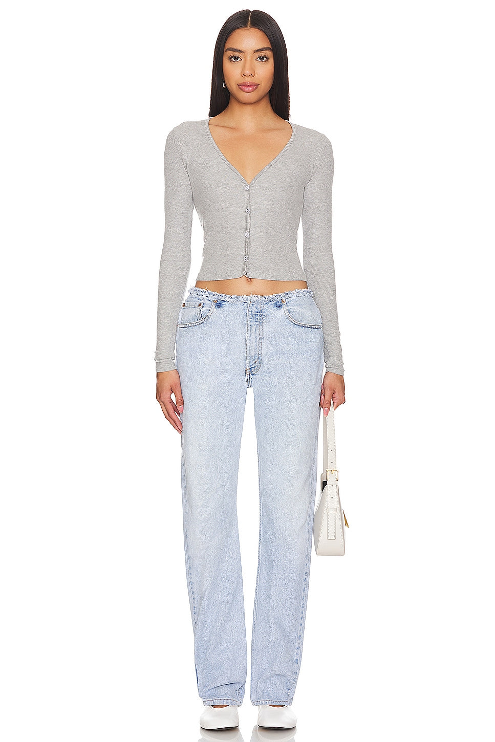 Model wearing an undone mini rise customs in a white background. 100% made from repurposed Levi’s. 