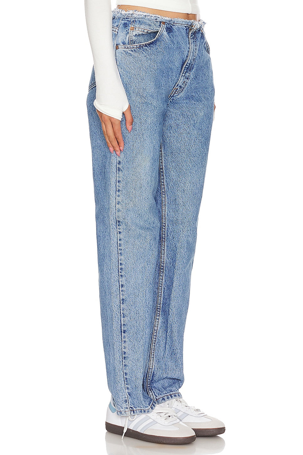 Model wearing an undone mini rise customs in a white background. 100% made from repurposed Levi’s. 