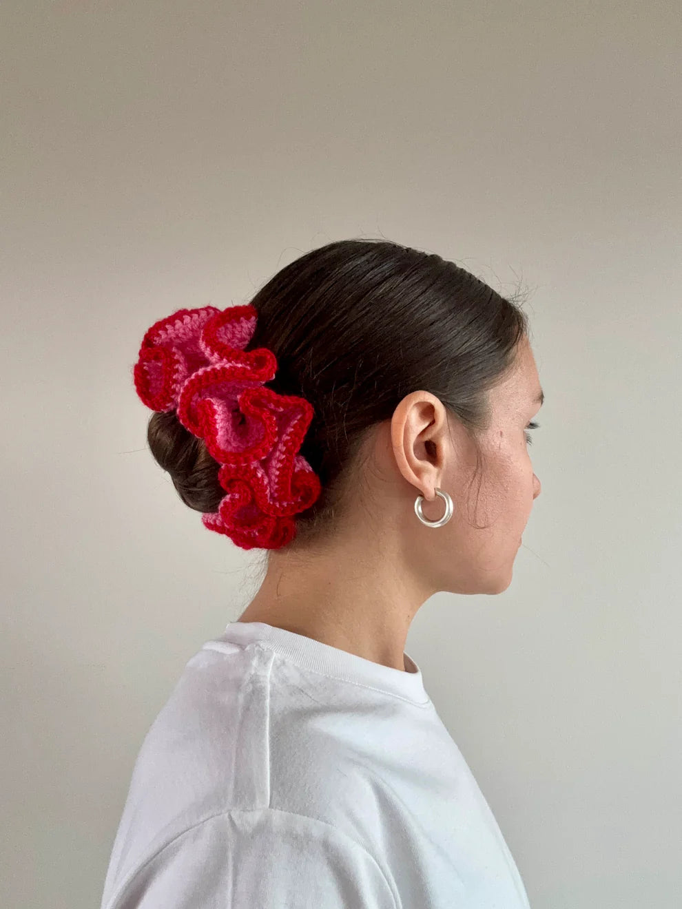 A model wearing the azaryiah scrunchie in a white background. Handmade in London!