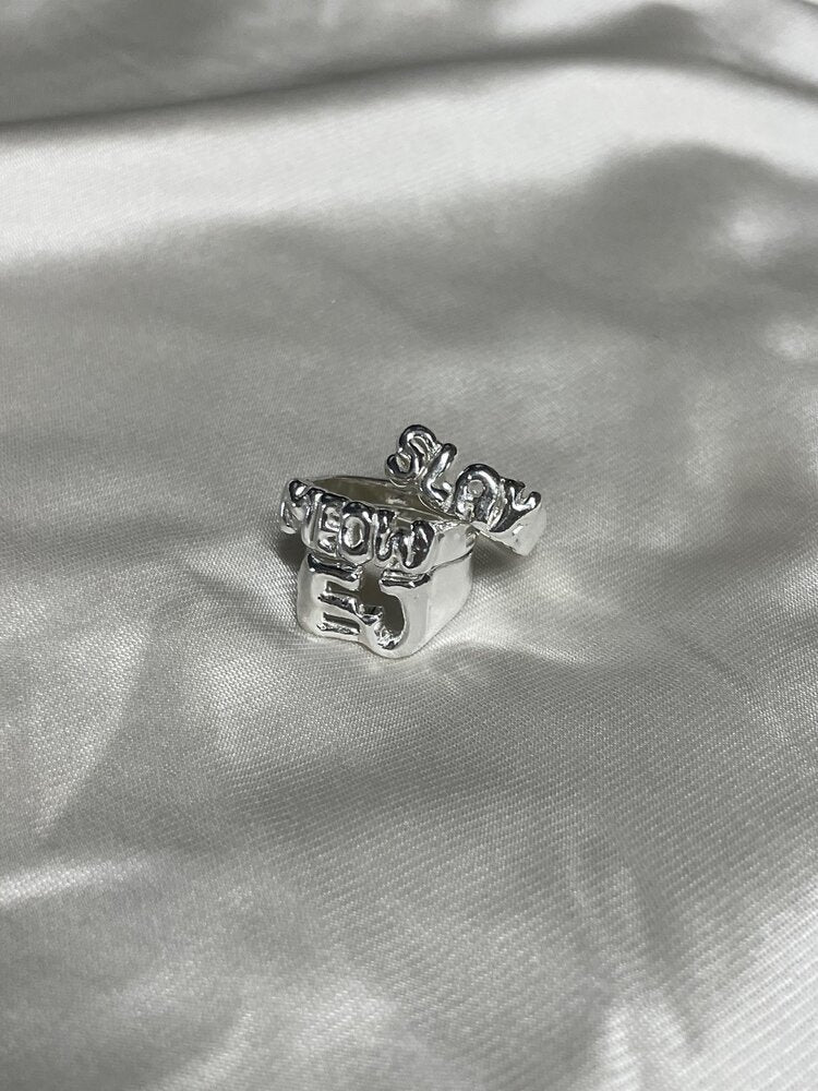 The custom letter ring in a white background. Made from 100% recycled metals and lab created gemstones. CLOSE UP