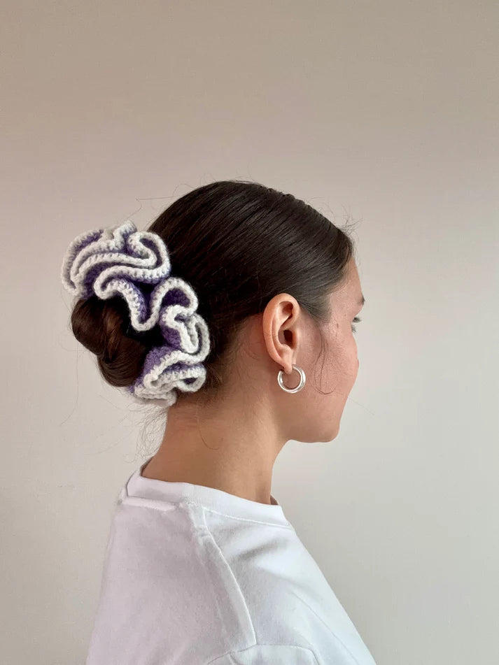 A model wearing the emma scrunchie in a white background. Handmade in London!