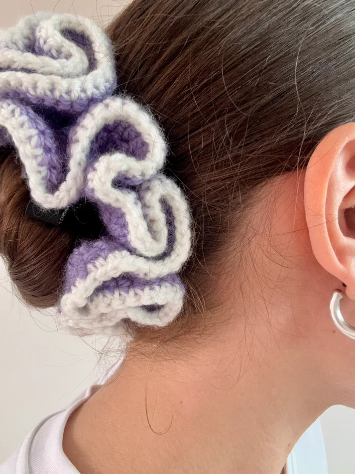 A model wearing the emma scrunchie in a white background. Handmade in London!