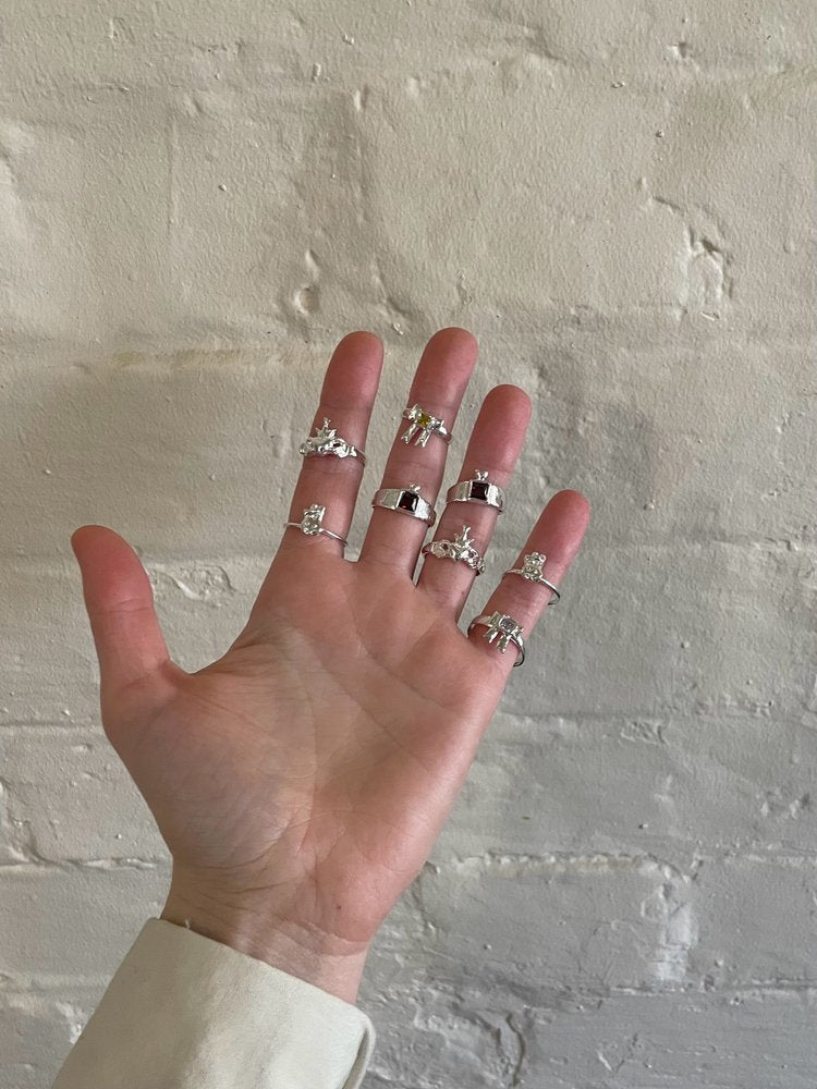 The heavens gate ring in a concrete background. Made from 100% recycled metals and lab created gemstones.