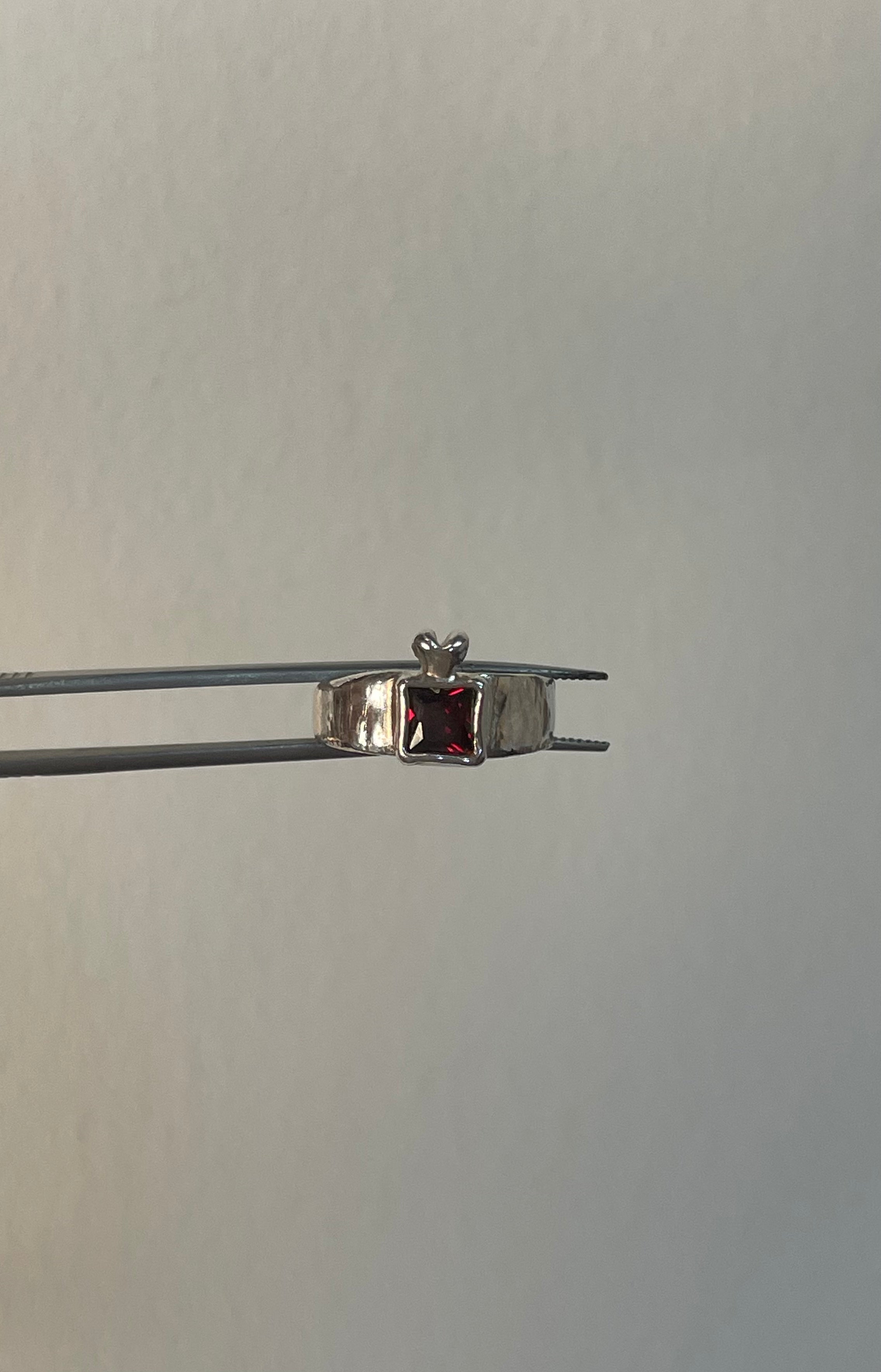 The heavens gate ring in a white background. Made from 100% recycled metals and lab created gemstones. CLOSE UP