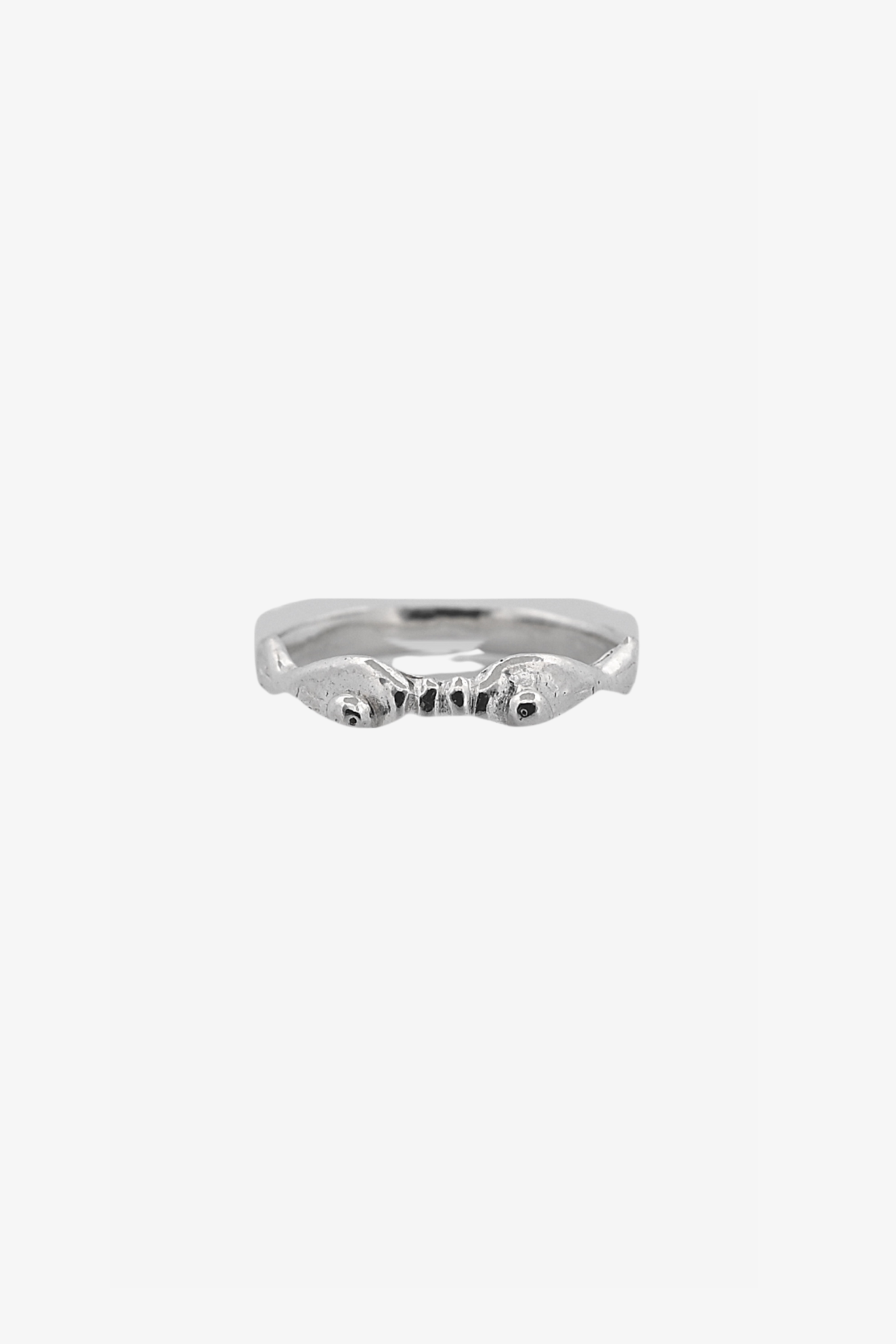 The kissing fish ring in a white background. Made from 100% recycled metals and lab created gemstones.