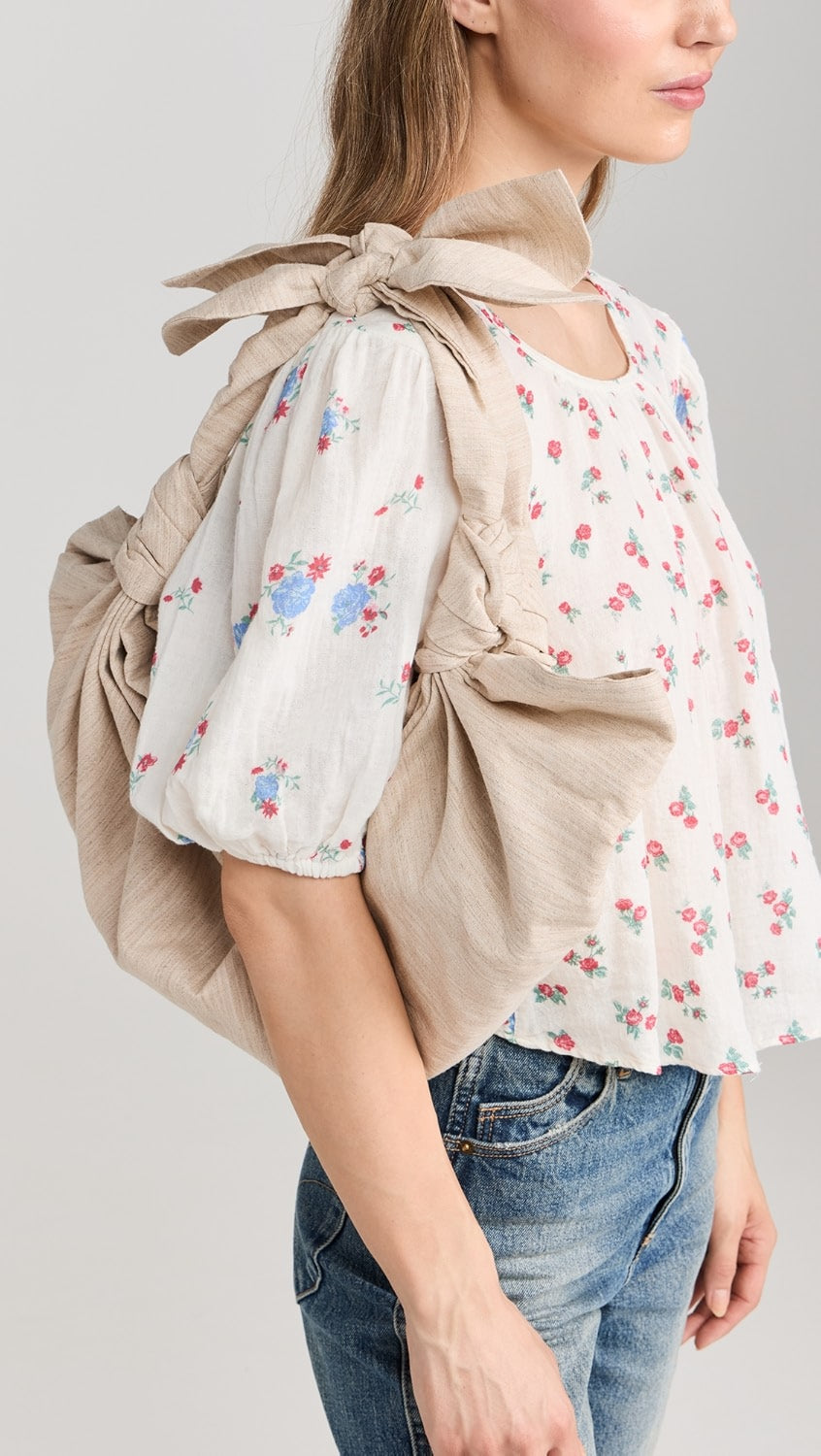 A model wearing the large linen tote bag in a white background. Deadstock linen fabric sourced in Los Angeles.