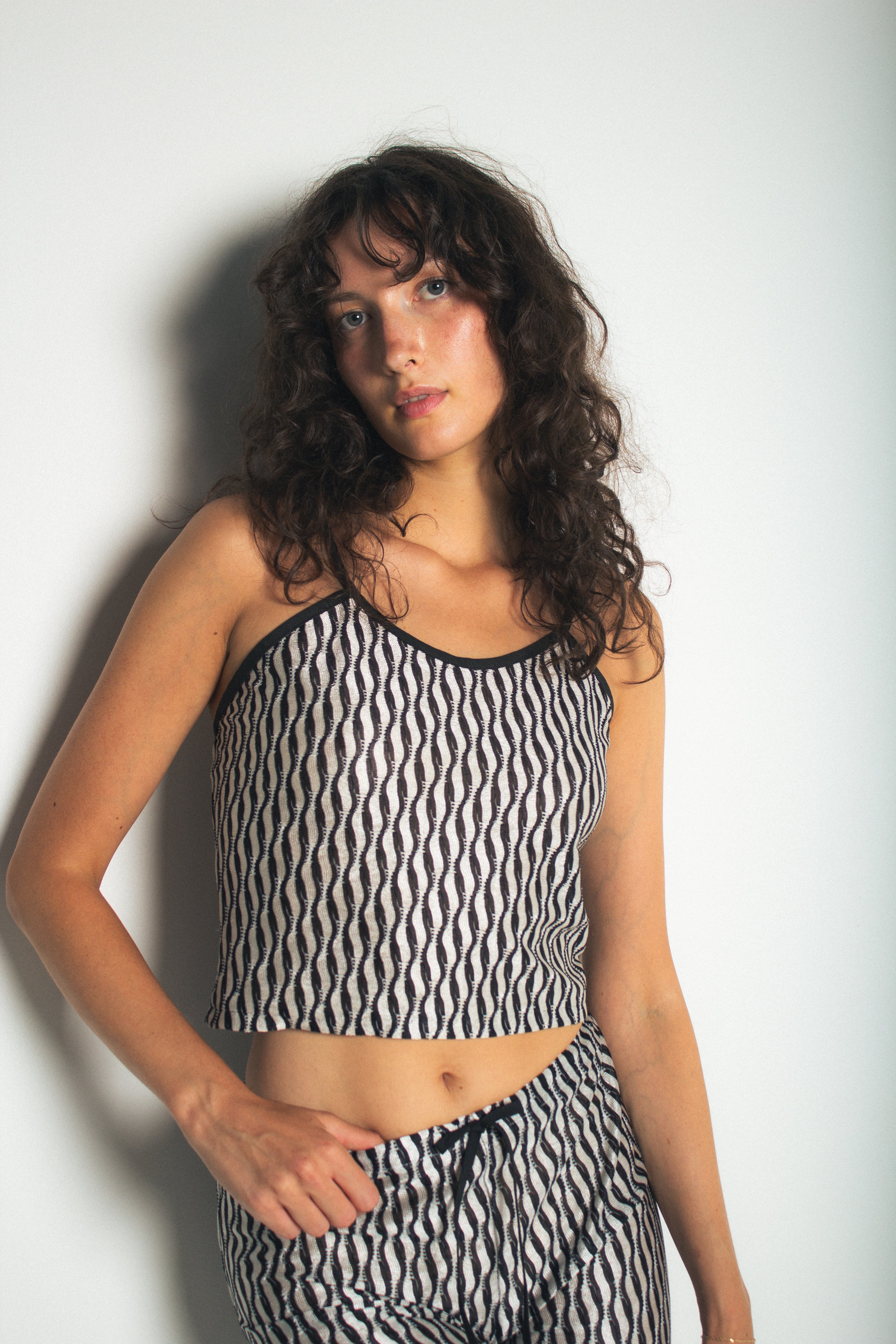 A model wearing the lola tank in a white background. 100% deadstock Missoni-like fabric