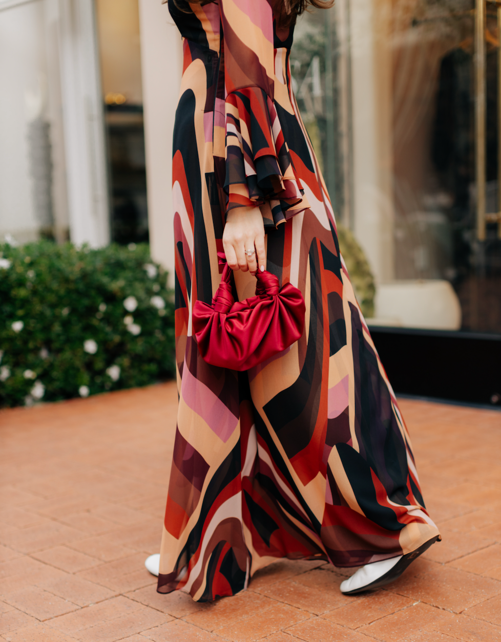 A model holding the merlot silk knot bag. Deadstock silky satin fabric sourced in Los Angeles.