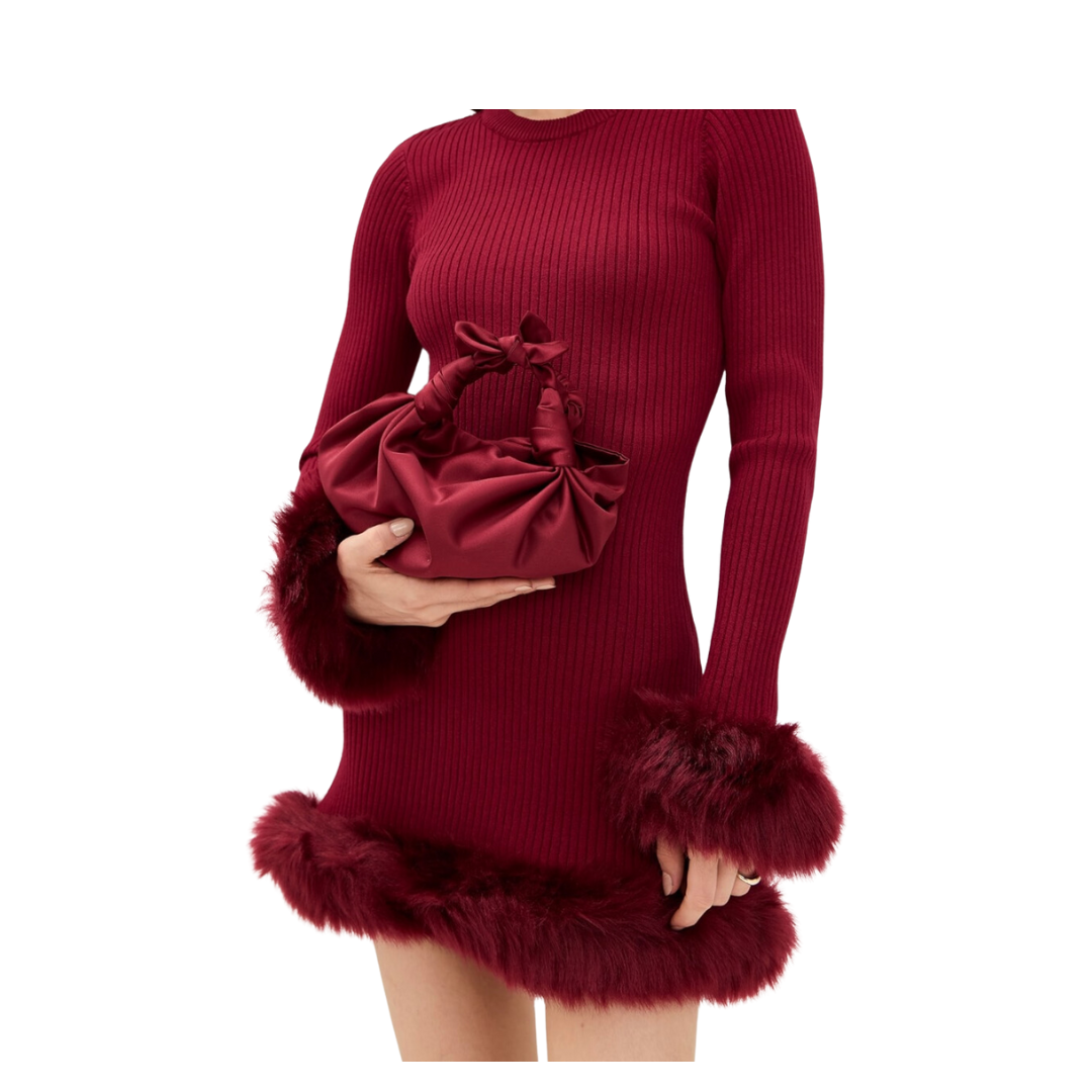 A model holding the merlot silk knot bag in a white background. Deadstock silky satin fabric sourced in Los Angeles.