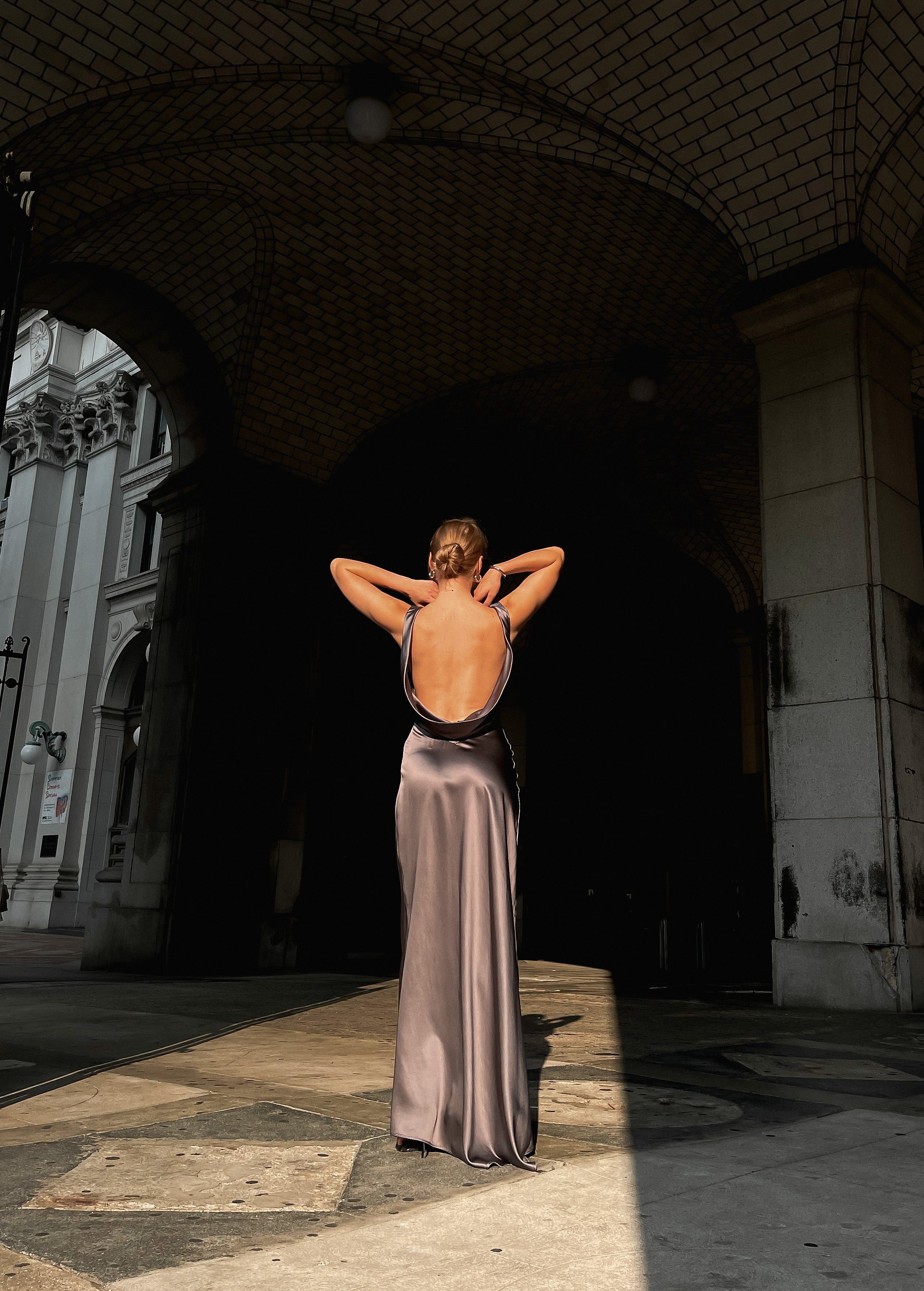 Beautiful model is wearing an open back Moonlight  maxi dress created from 100% luxurious silk